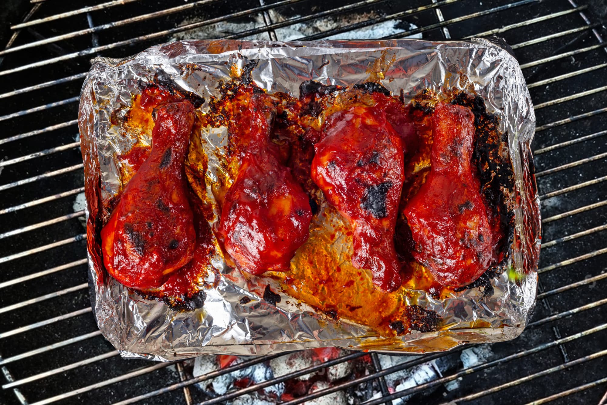 chicken-drumsticks-on-foil-on-a-grill