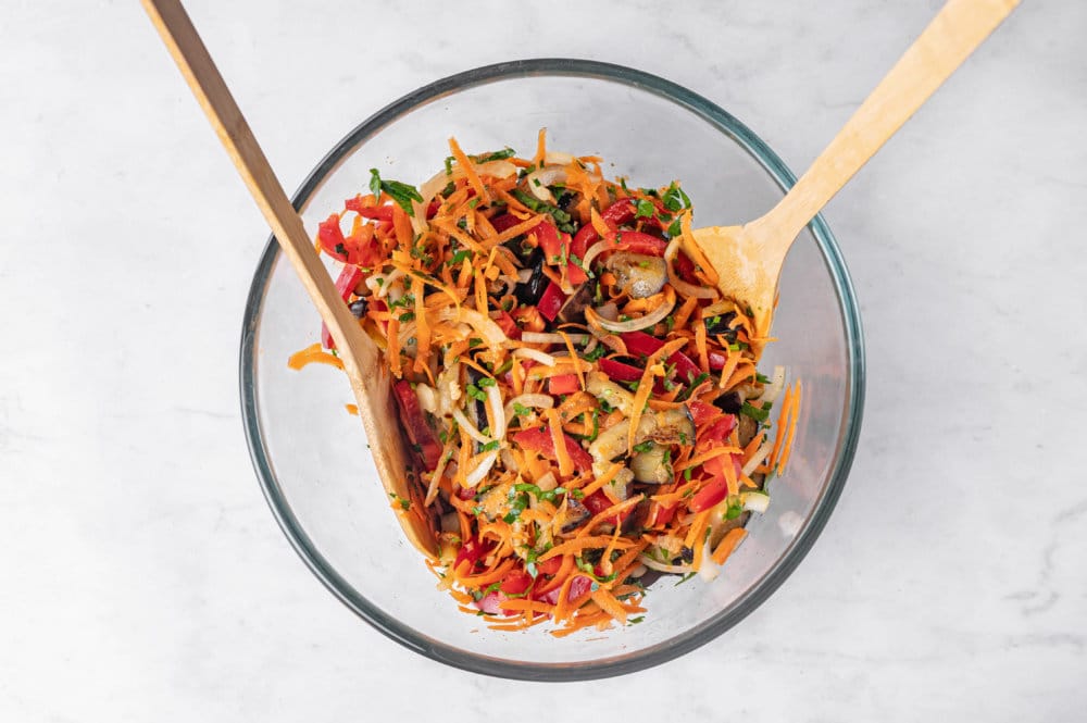 eggplant-salad-in-clear-bowl-with-wooden-spoons