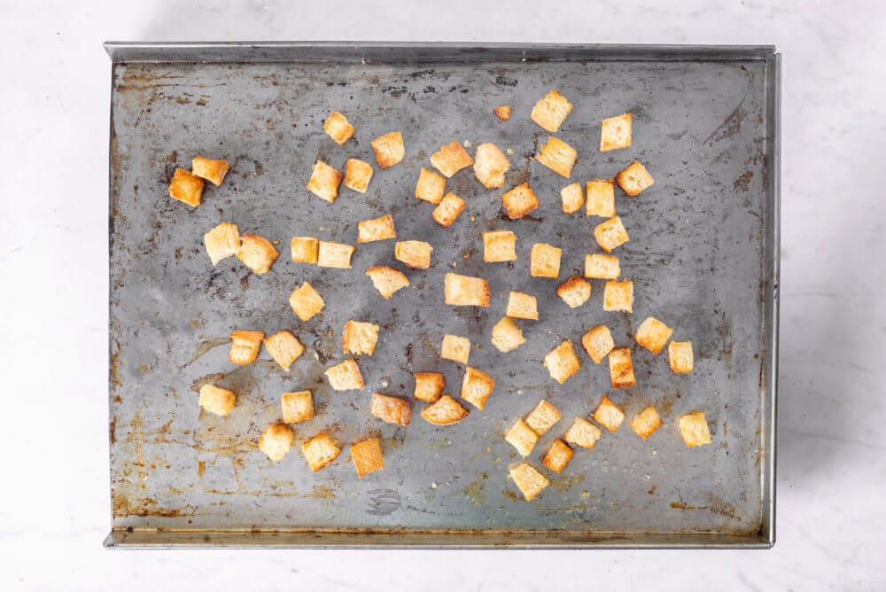 fresh toasted croutons on a baking tray.