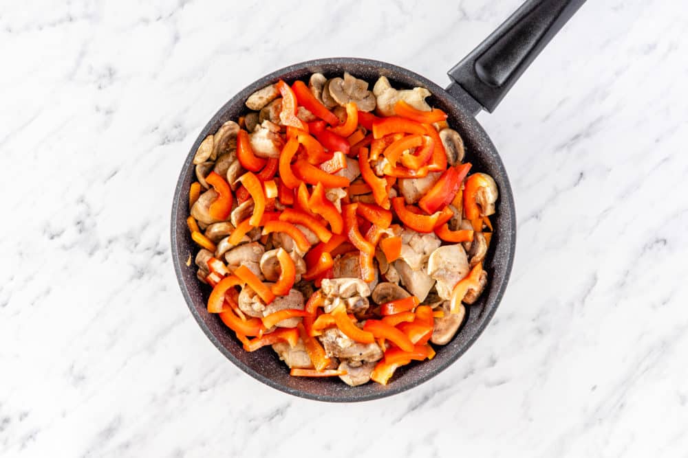 veggies and chicken in a pan.