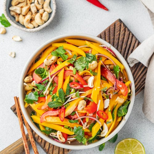 a white bowl filled with mixed thai chopped salad.