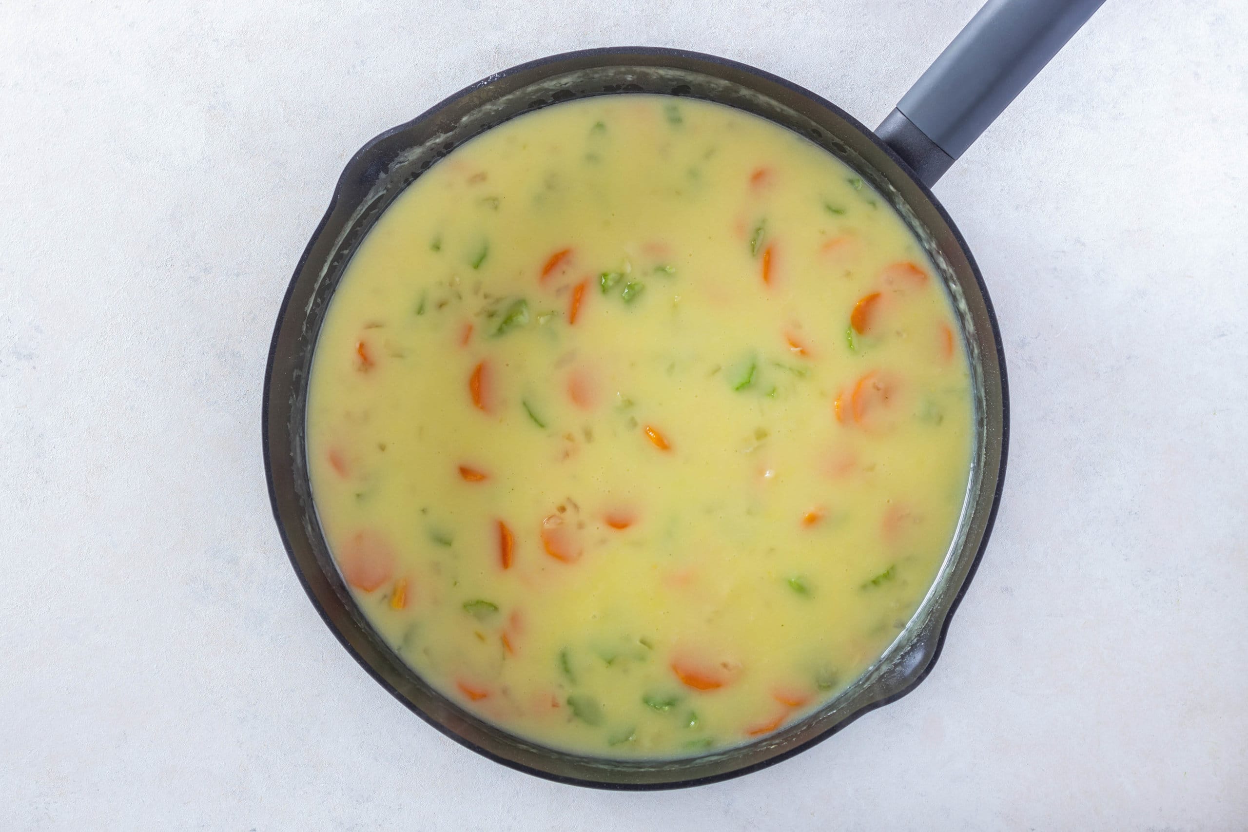 chicken pot pie filling thickening in a skillet