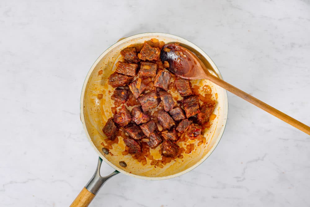 beef-sauteing-in-a-skillet-with-a-wooden-spoon