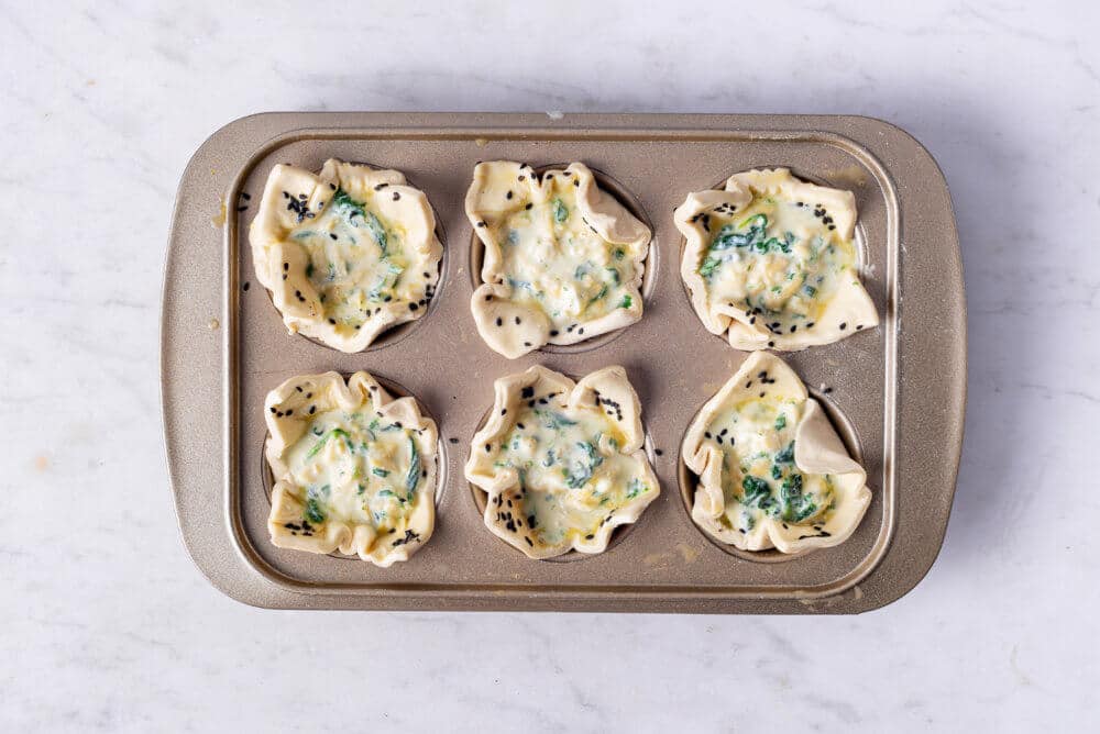 spinach puffs in a muffin tray.