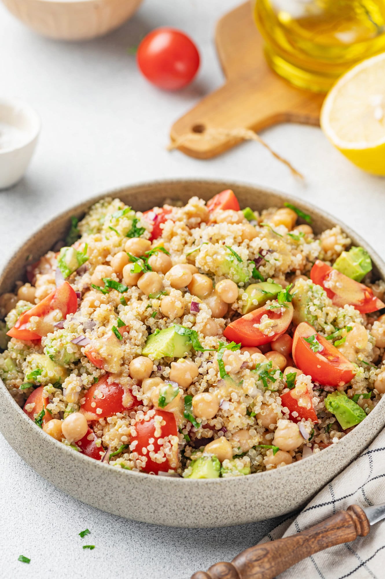 Quinoa chickpea salad in a grey bowl.