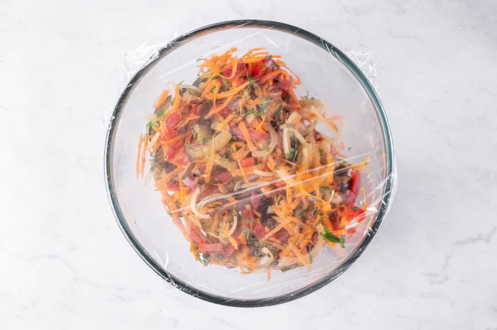 eggplant-salad-in-a-clear-bowl-with-plastic-wrap