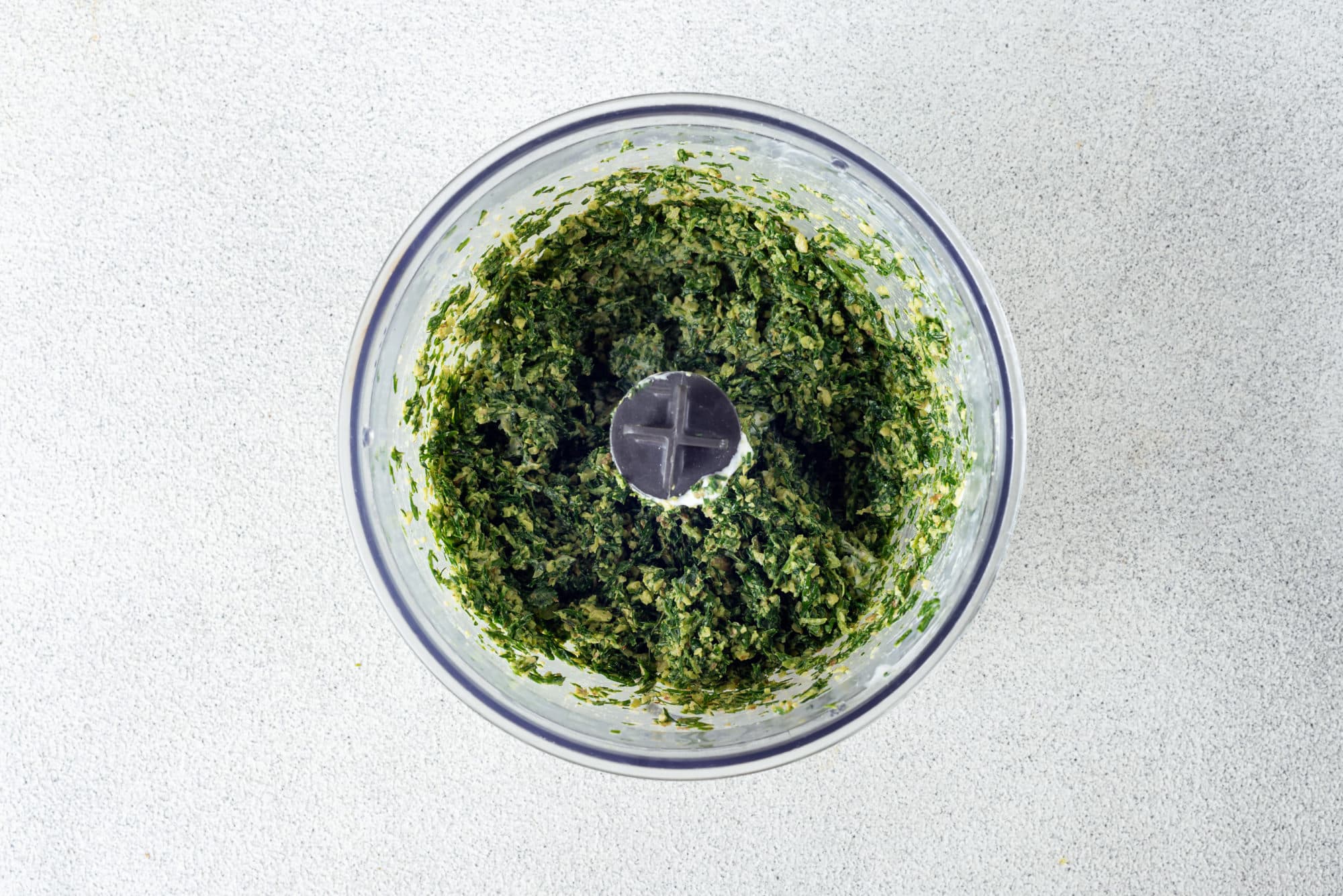 blended herb filling in a food processor.