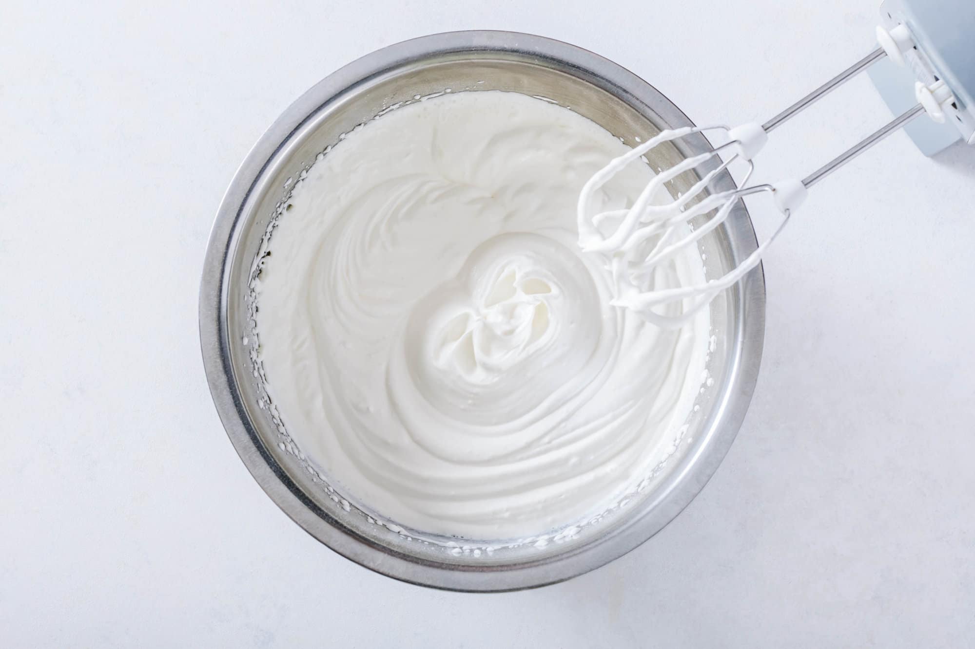 mousse-for-mandarin-orange-cake-in-silver-bowl-with-hand-mixer