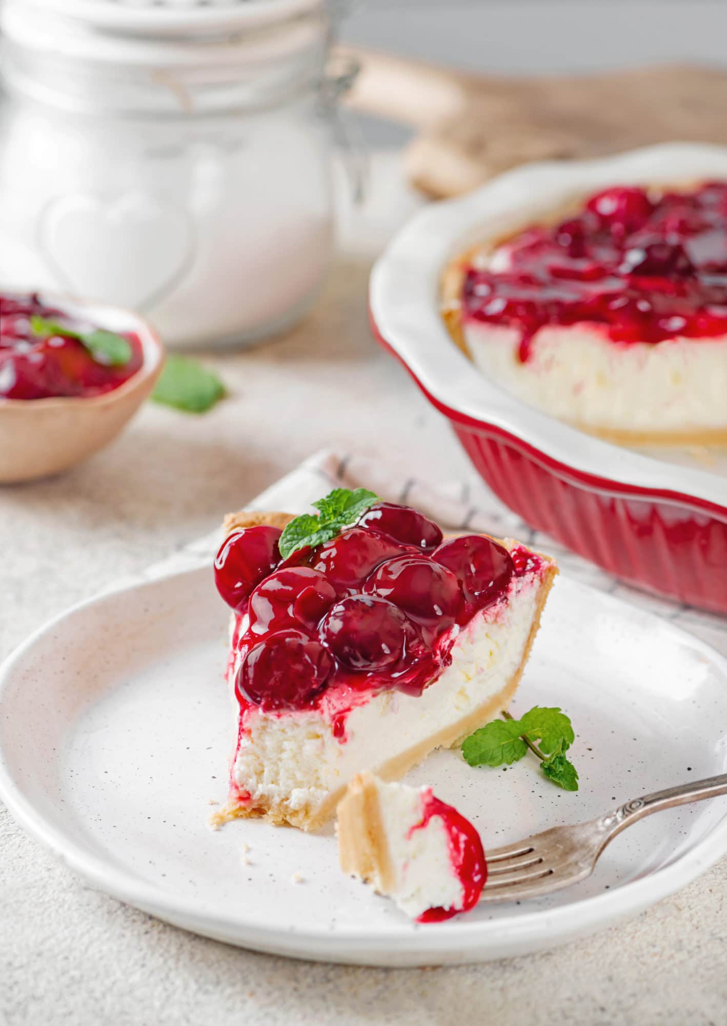 slice of no bake cherry cheesecake on a plate. 