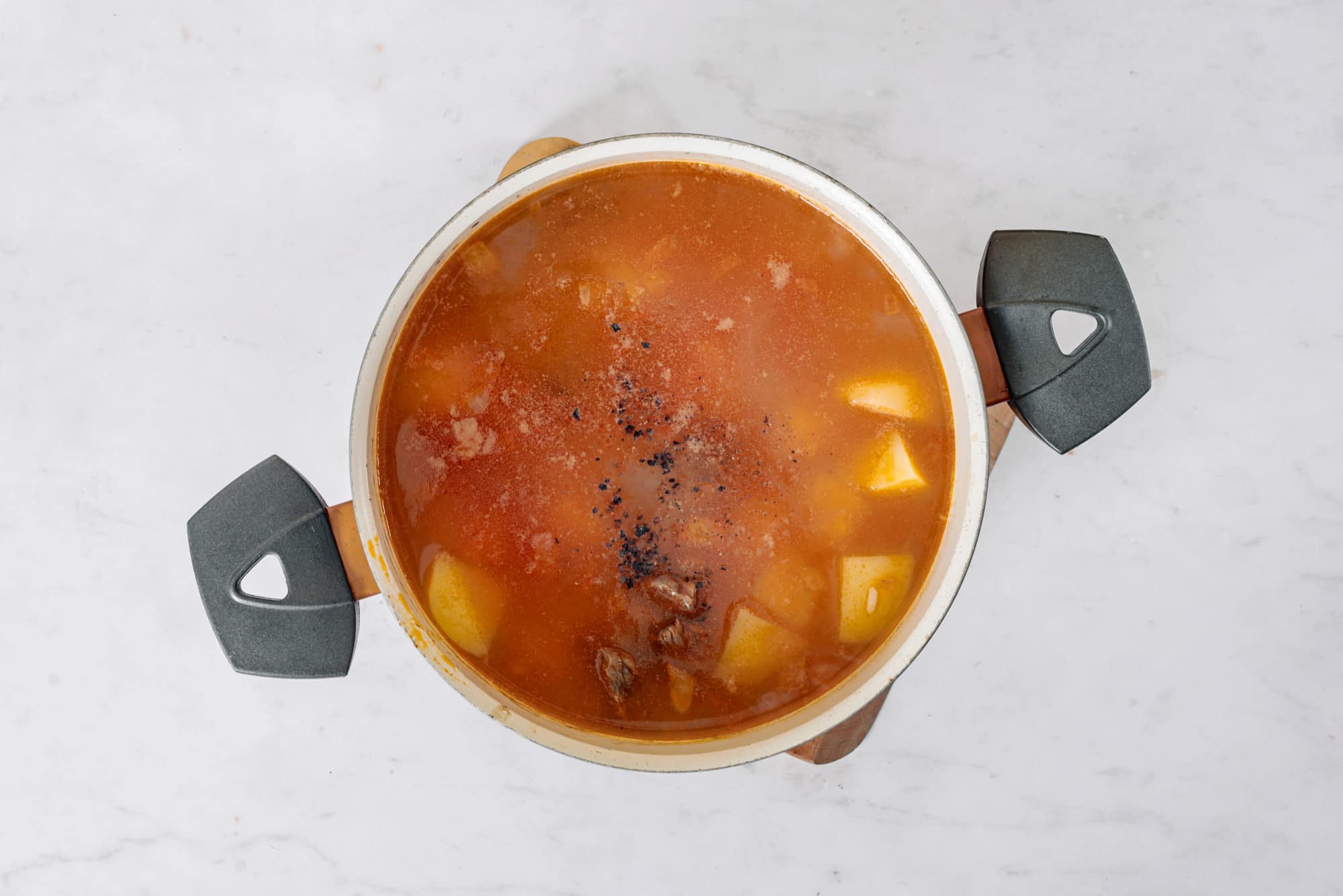 beef-soup-in-a-pot-on-a-wooden-board