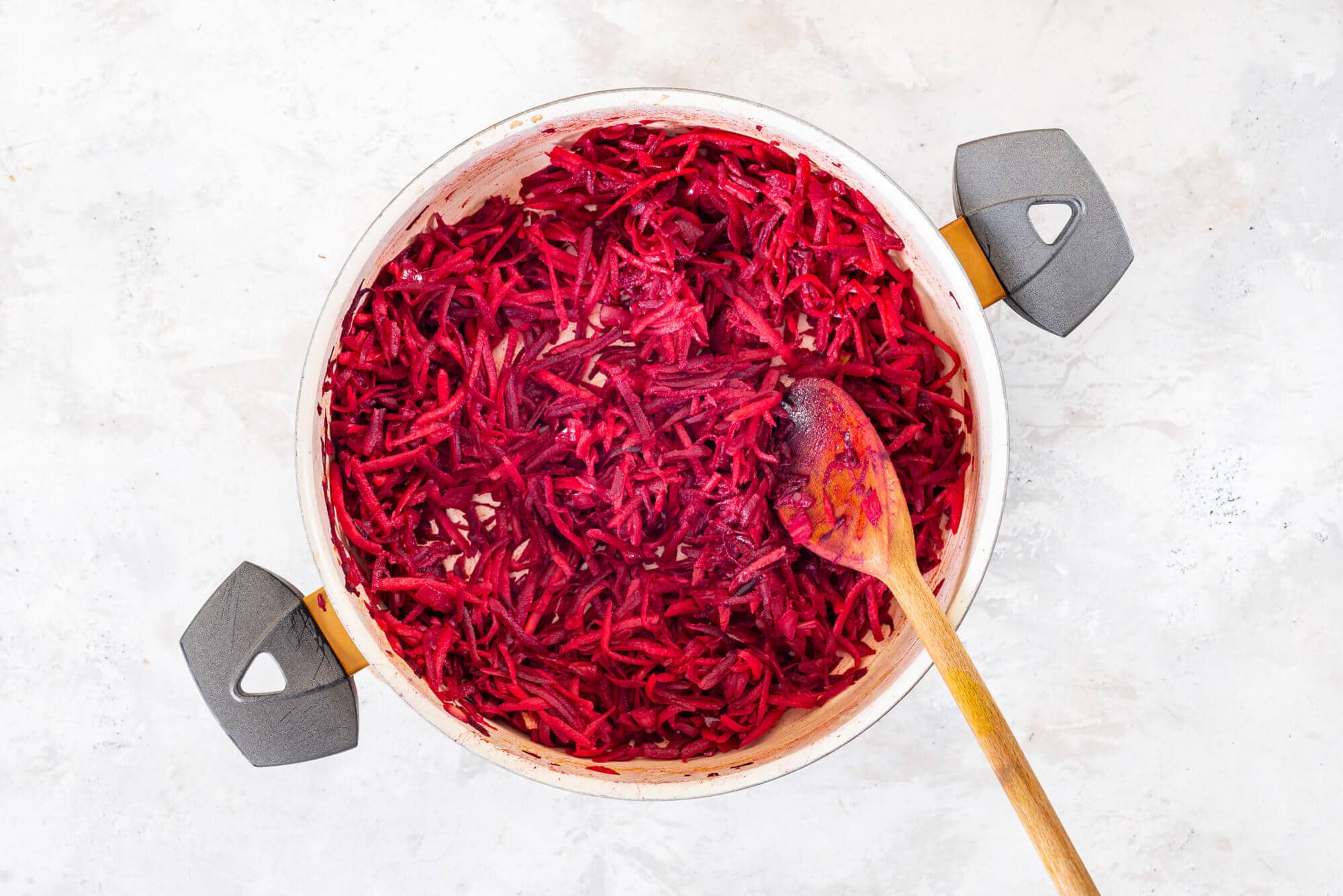 grated-beets-in-a-skillet-with-a-wooden-spoon