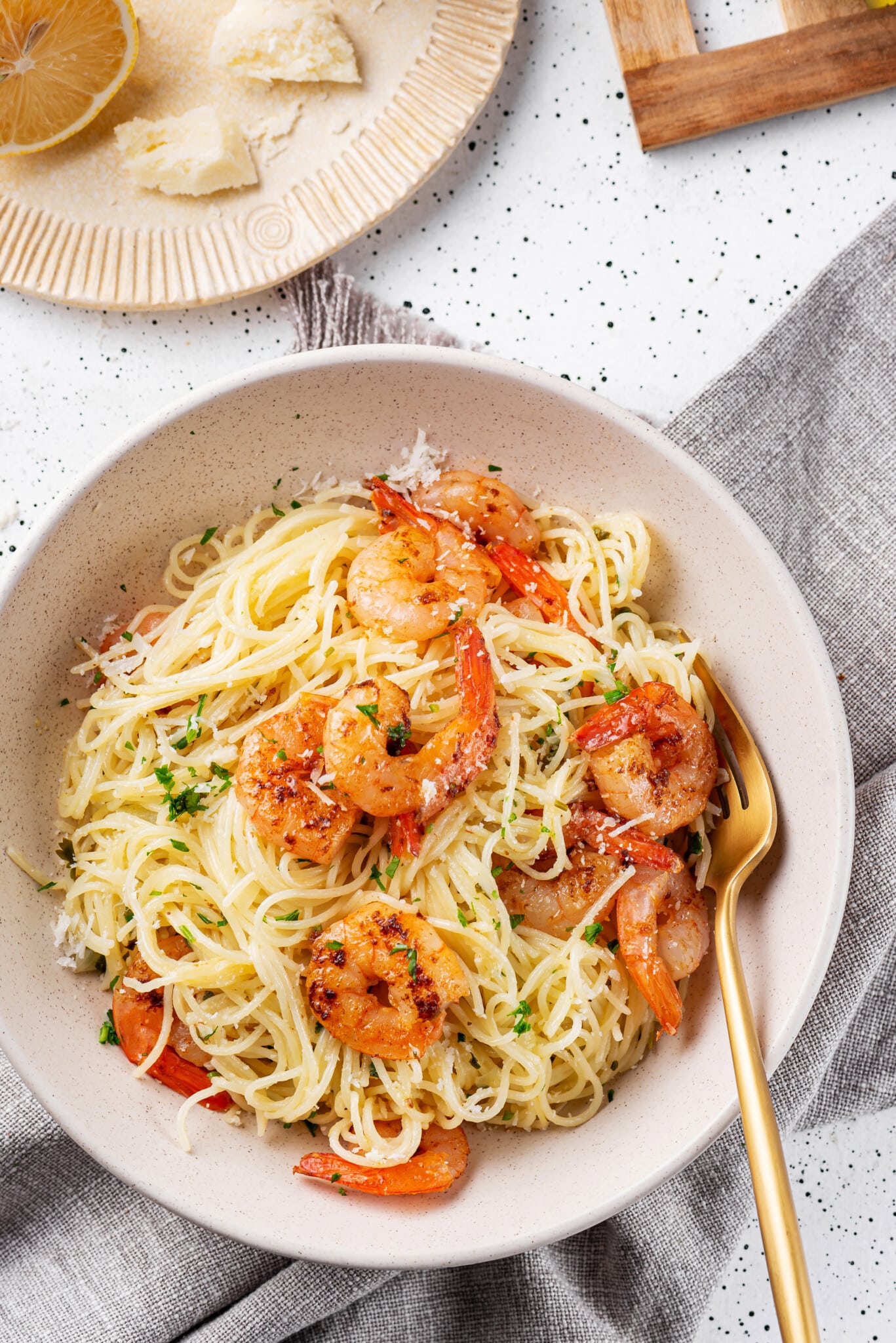 capellini-shrimp-in-a-bowl-with-a-gold-fork-on-a-grey-towel