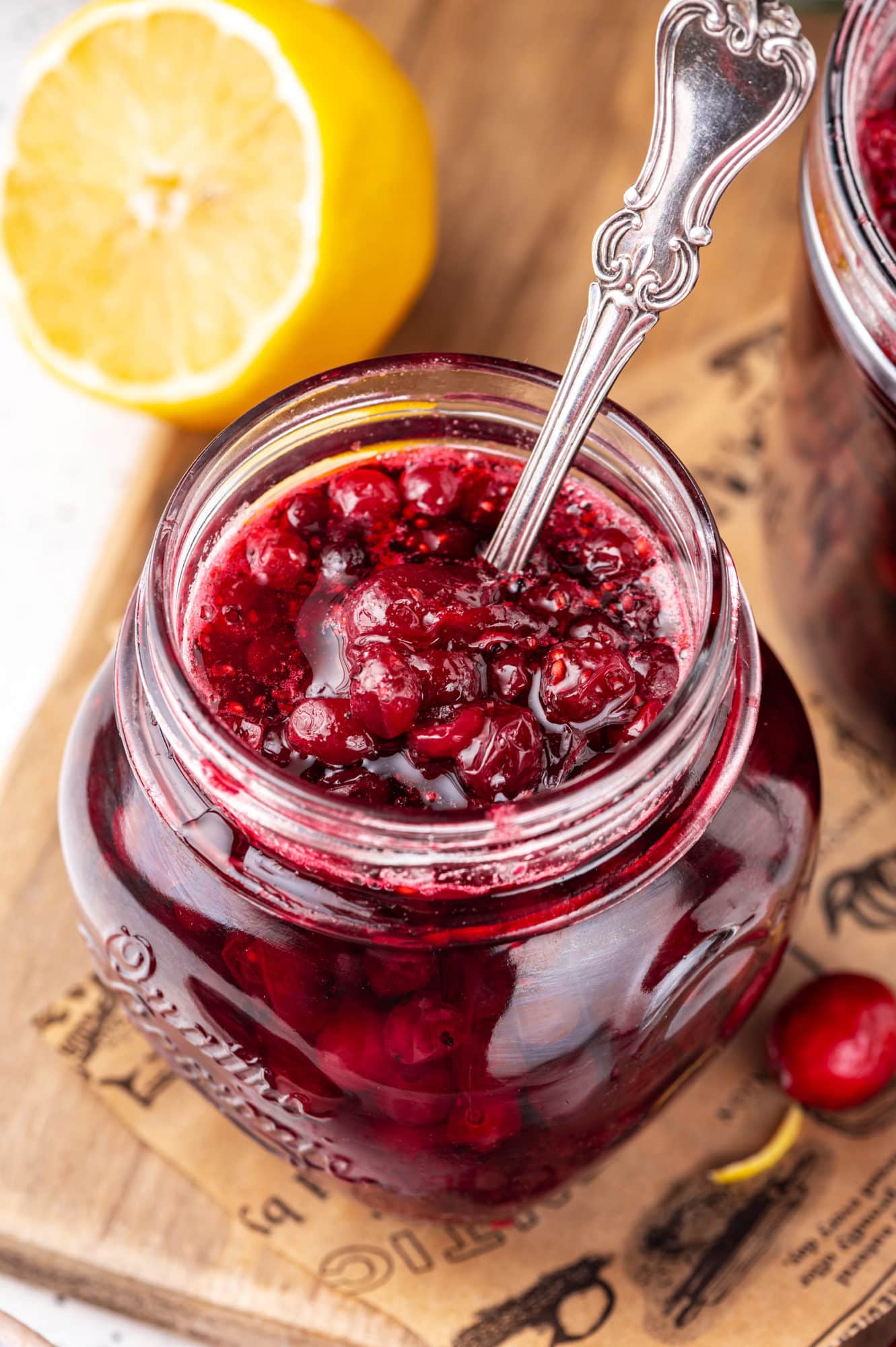 cranberry-sauce-in-glass-jars-with-a-spoon-on-a-wooden-board