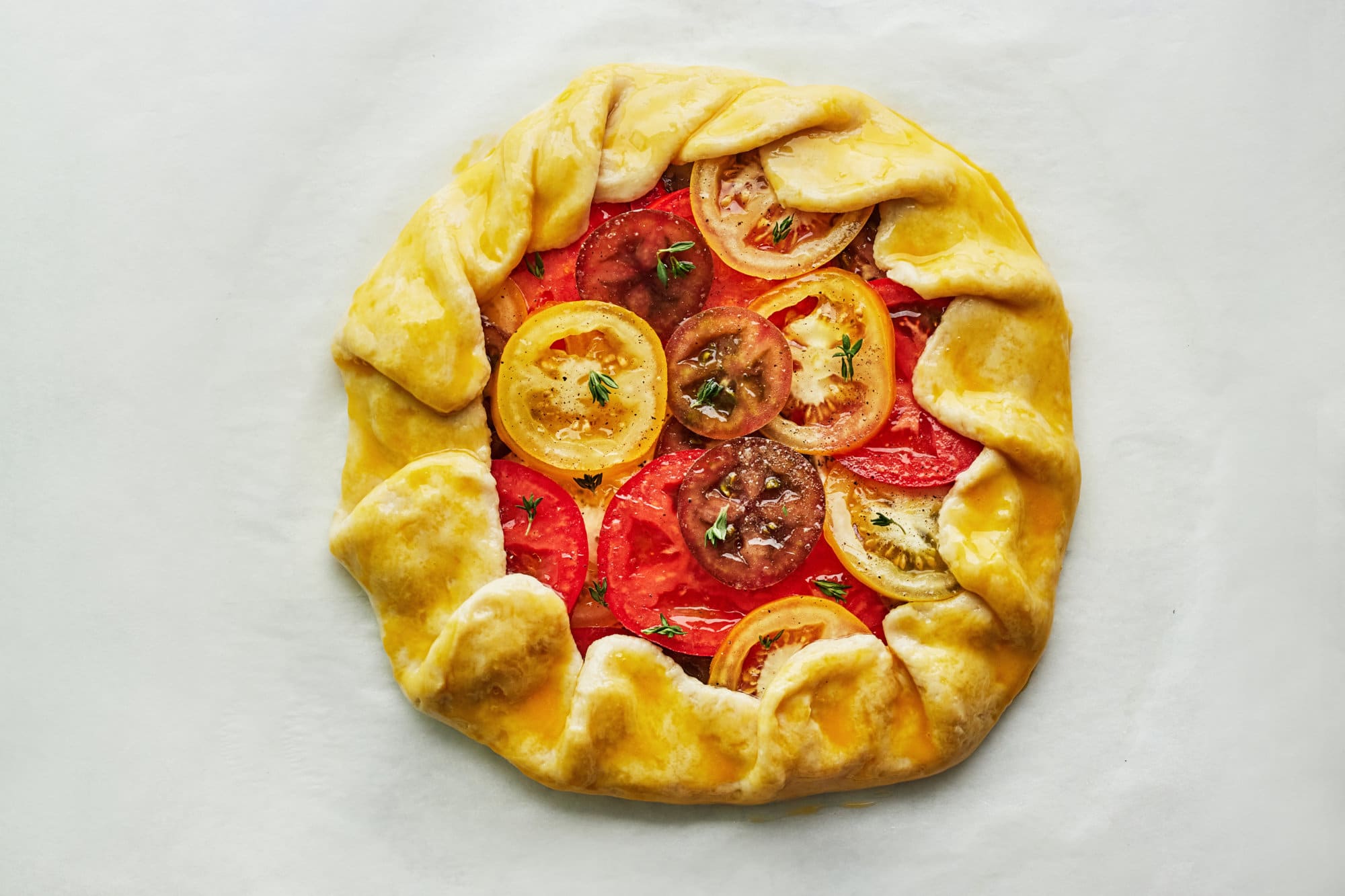 baked tomato galette on parchment paper.