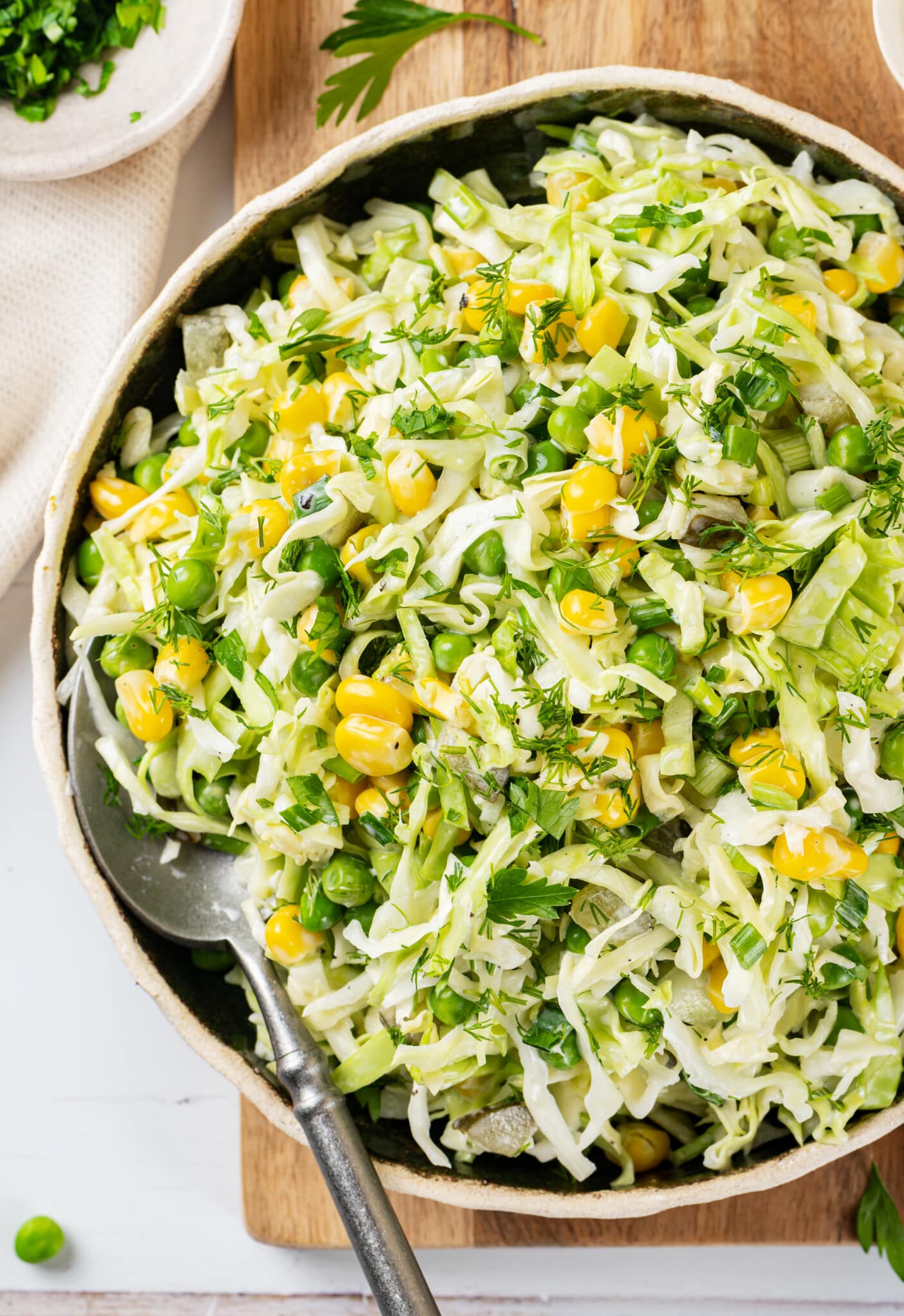 cabbage-salad-in-a-white-bowl-on-a-wooden-board-with-a-spoon