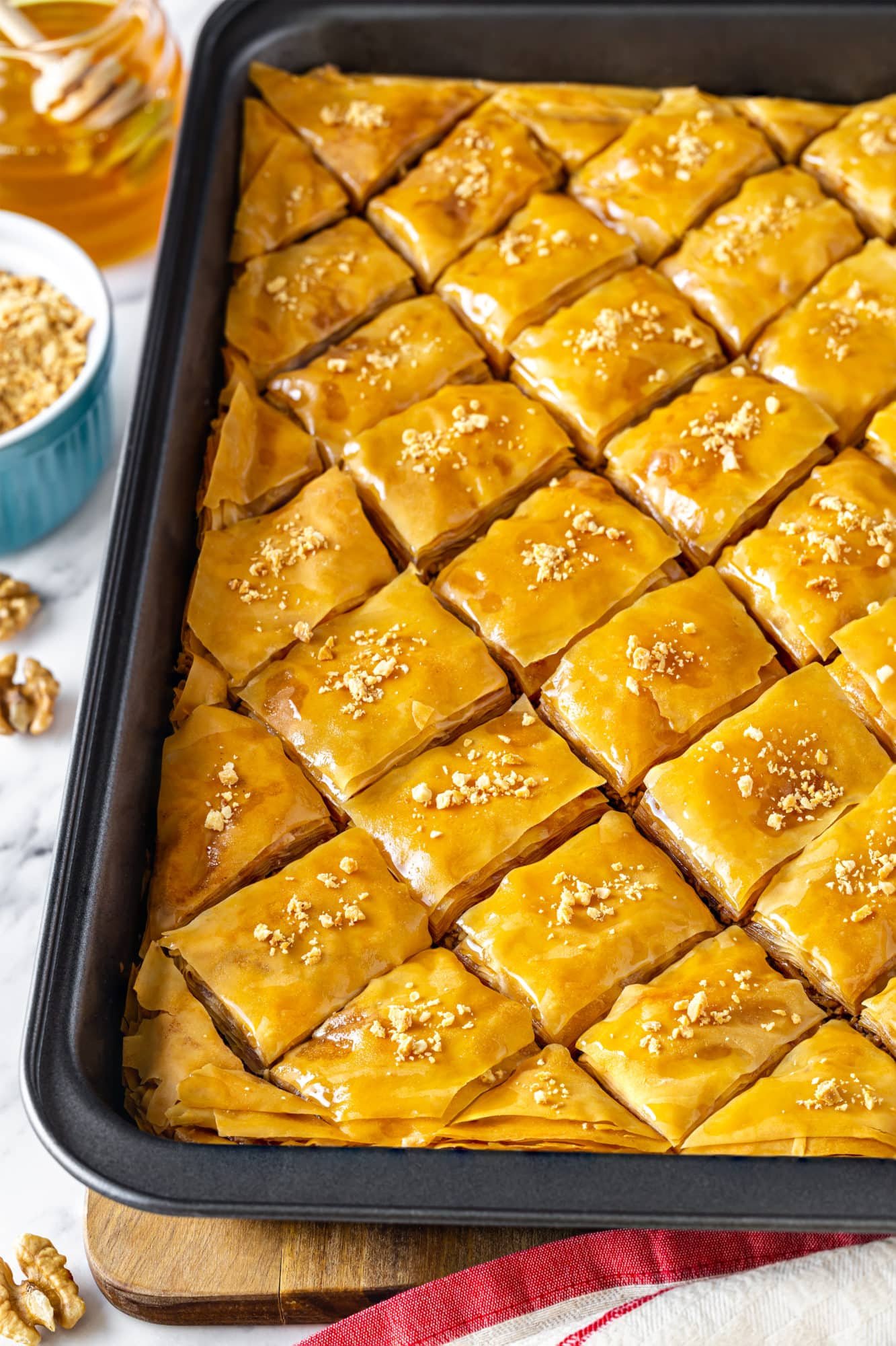 golden baklava prepared and cut in a baking tray.