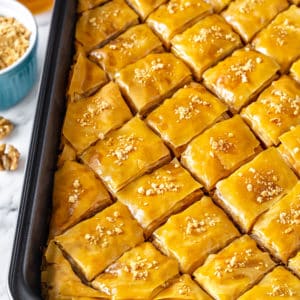 golden baklava prepared and cut in a baking tray.