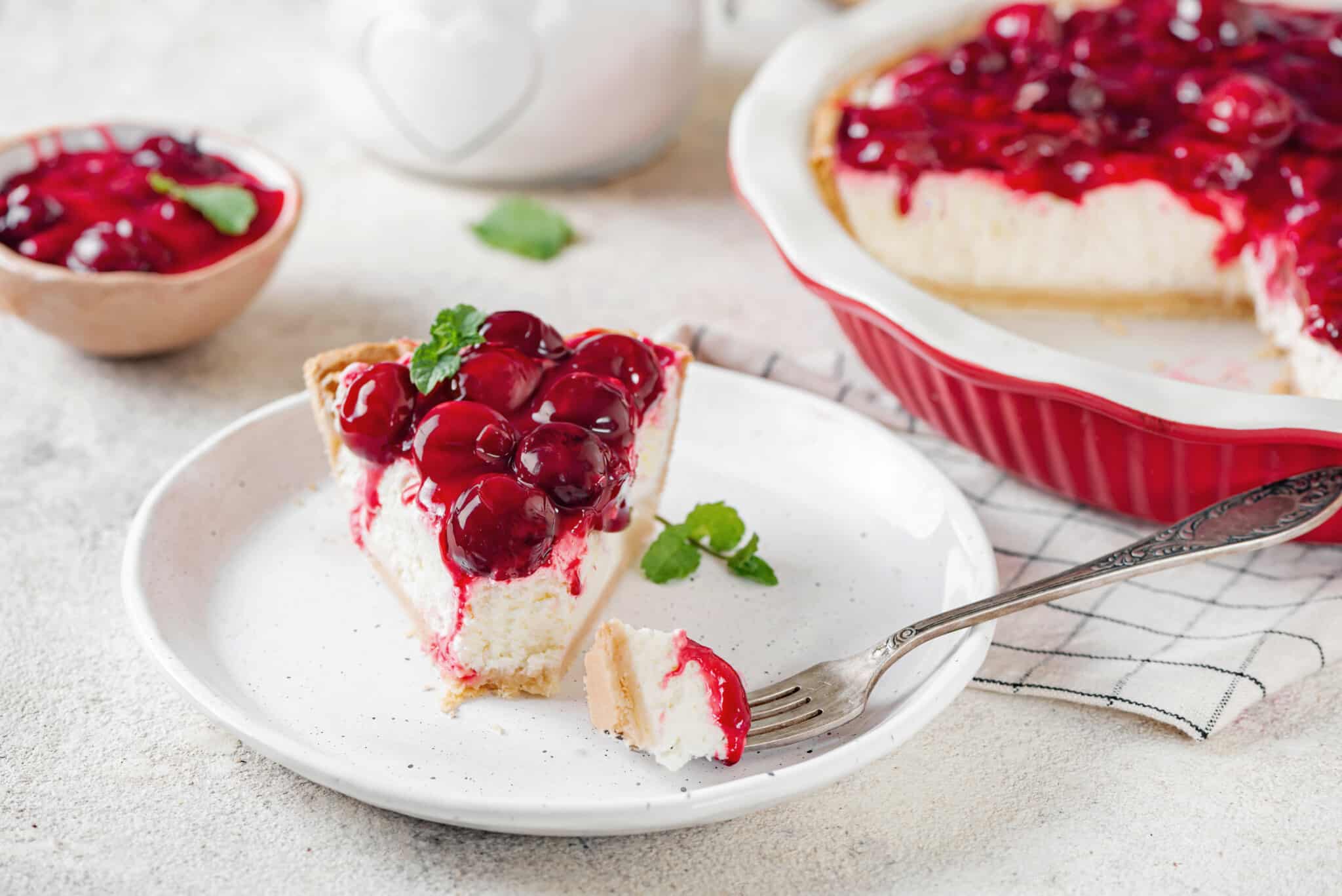 cheesecake-slice-on-a-white-plate-with-a-fork