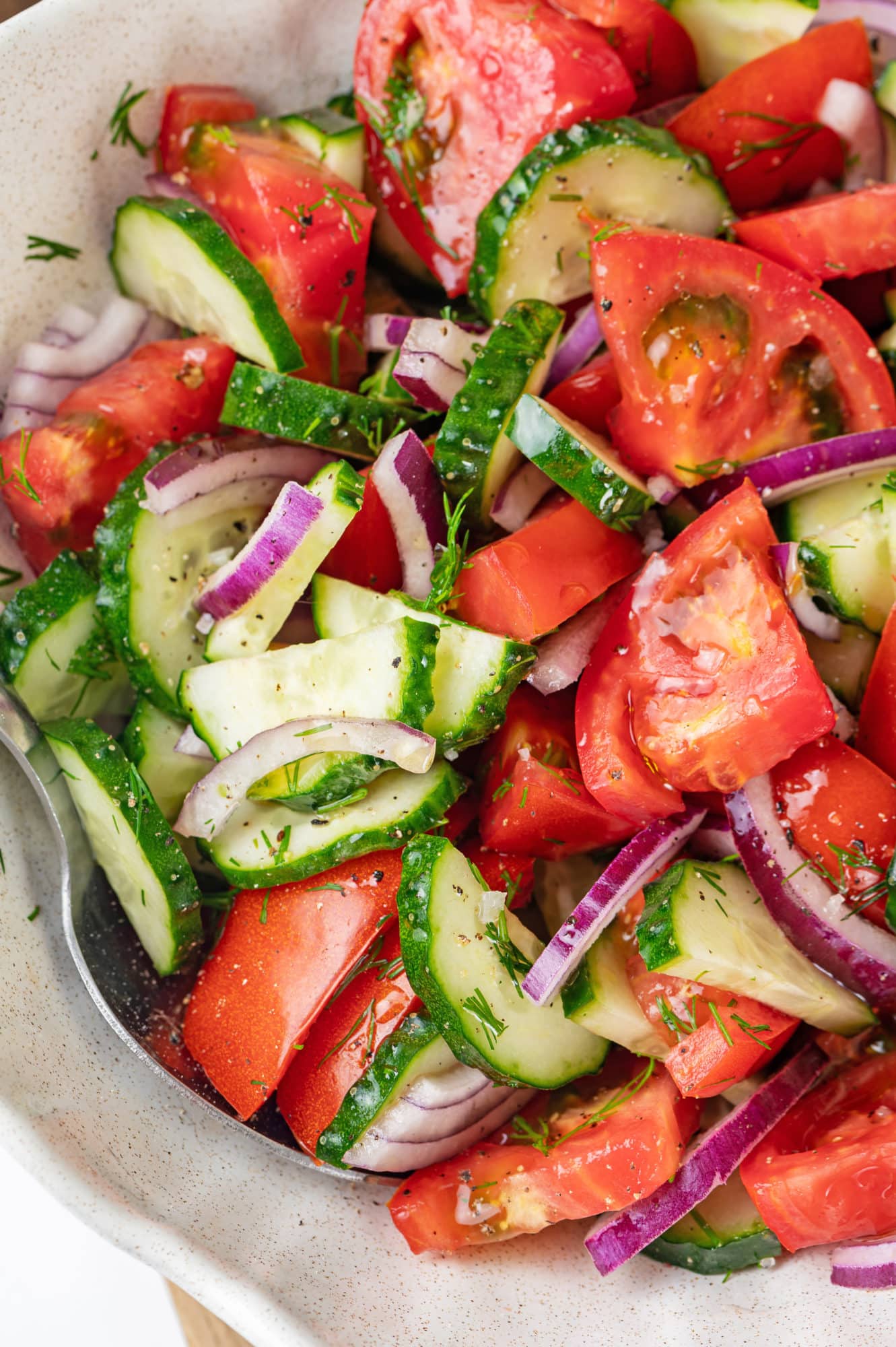 summer-salad-in-a-white-bowl-with-a-spoon