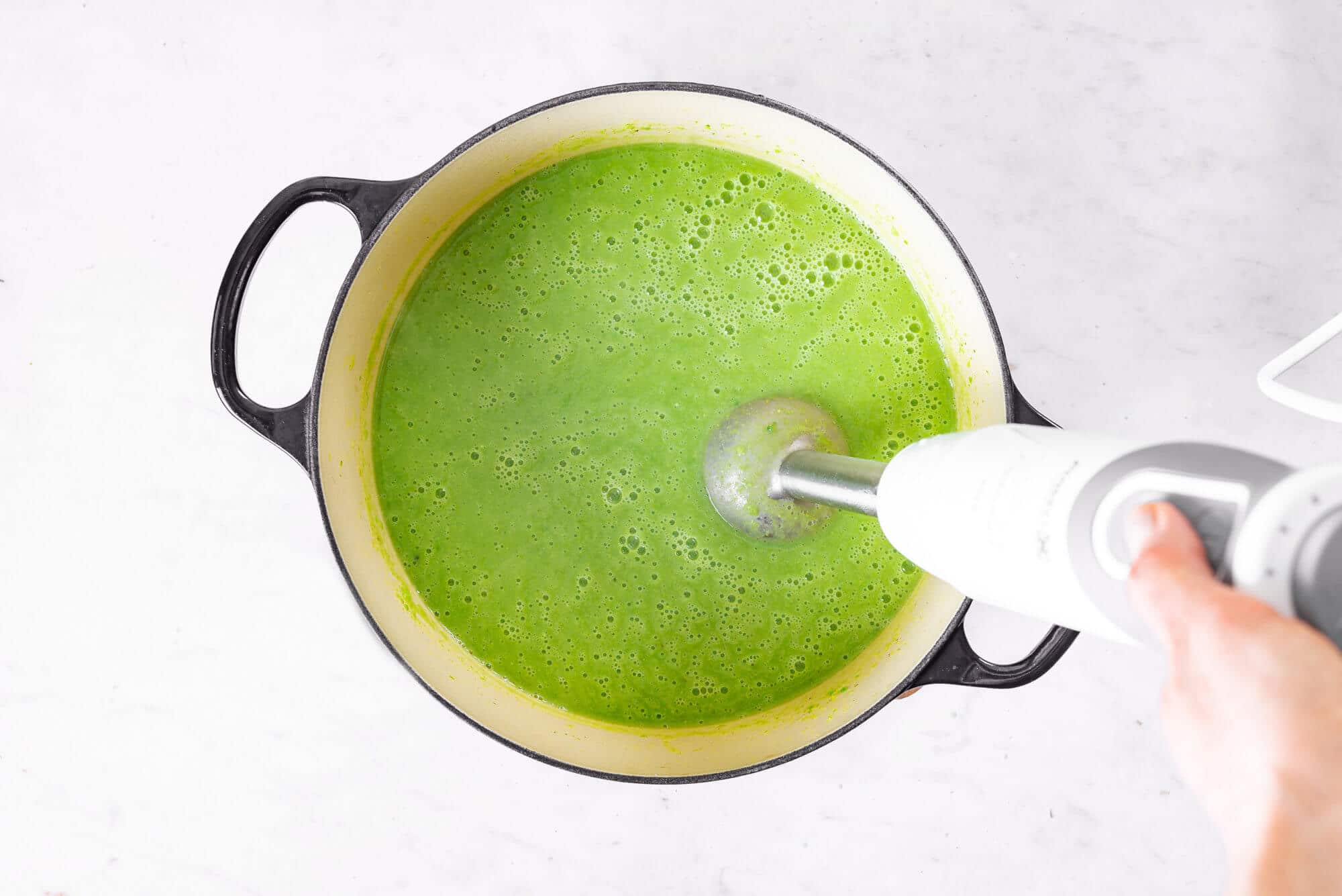 pea-soup-in-a-soup-pot-being-blended-with-an-immersion-blender