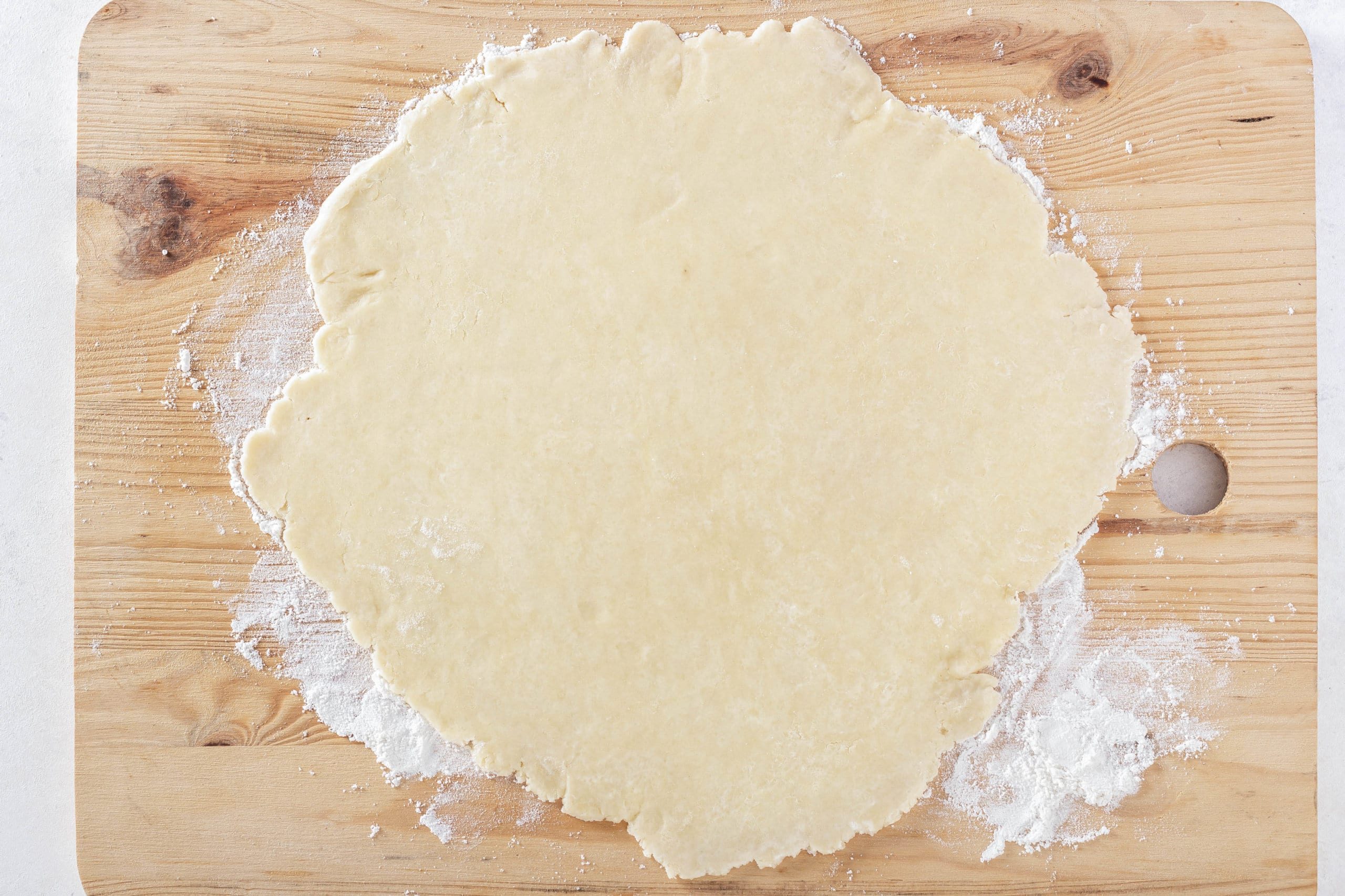 easy pie crust rolled out on a wooden board