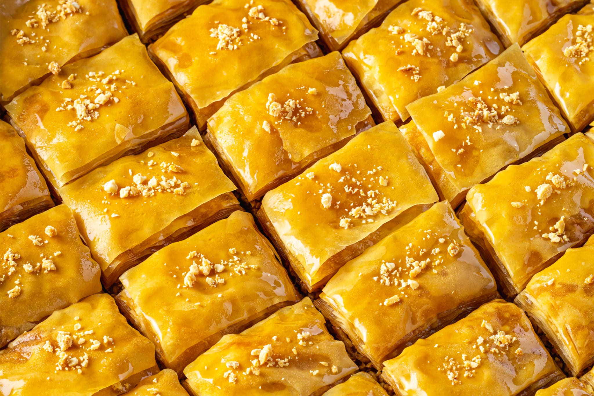 close up of  prepared baklava with walnut pieces on top.