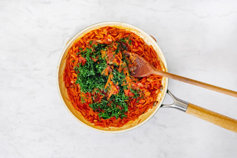 sauteing-soup-ingredients-in-a-skillet-with-a-wooden-spoon