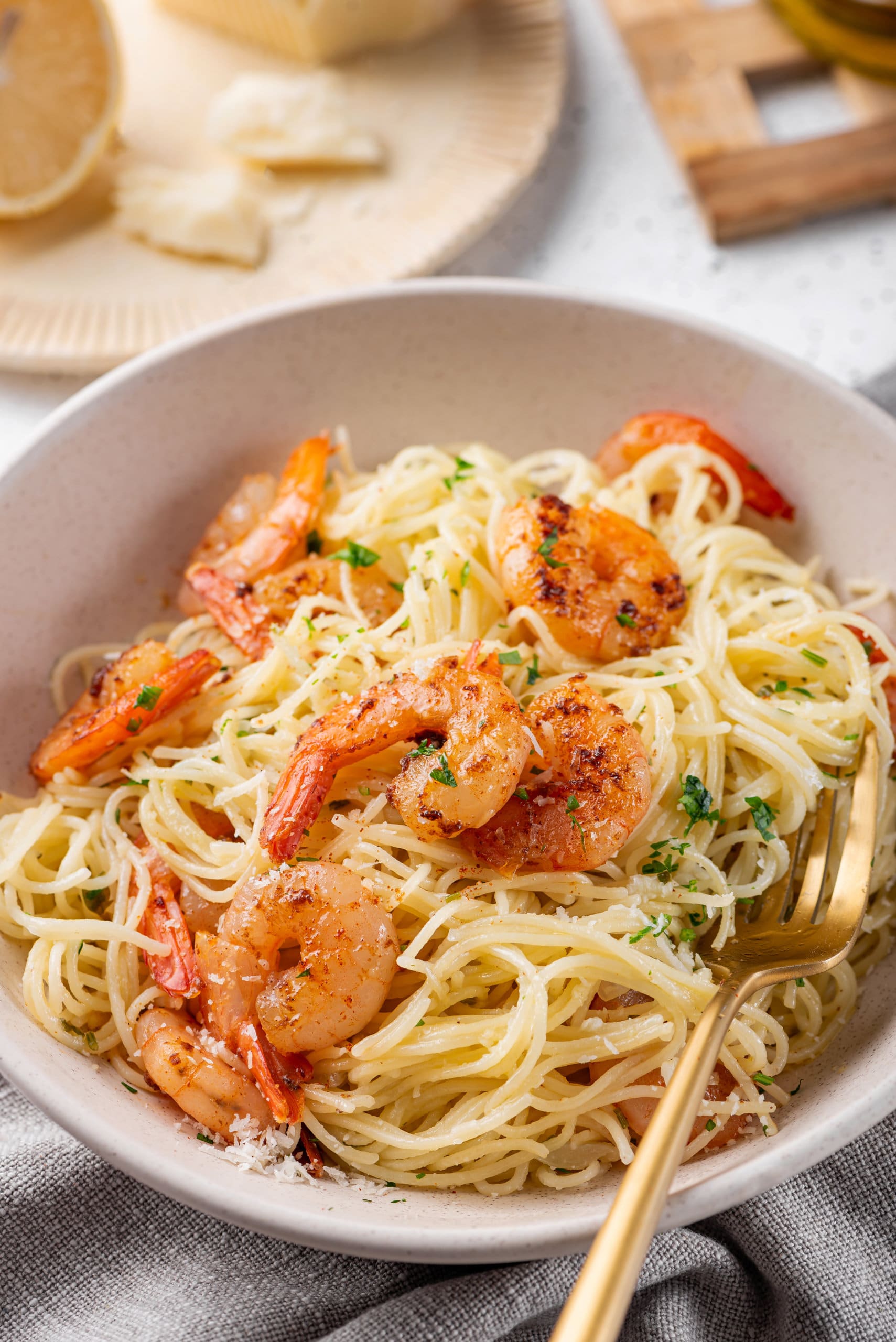 a bowl full of Capellini Pasta with a Simple White Wine Sauce and garlic Butter Shrimp