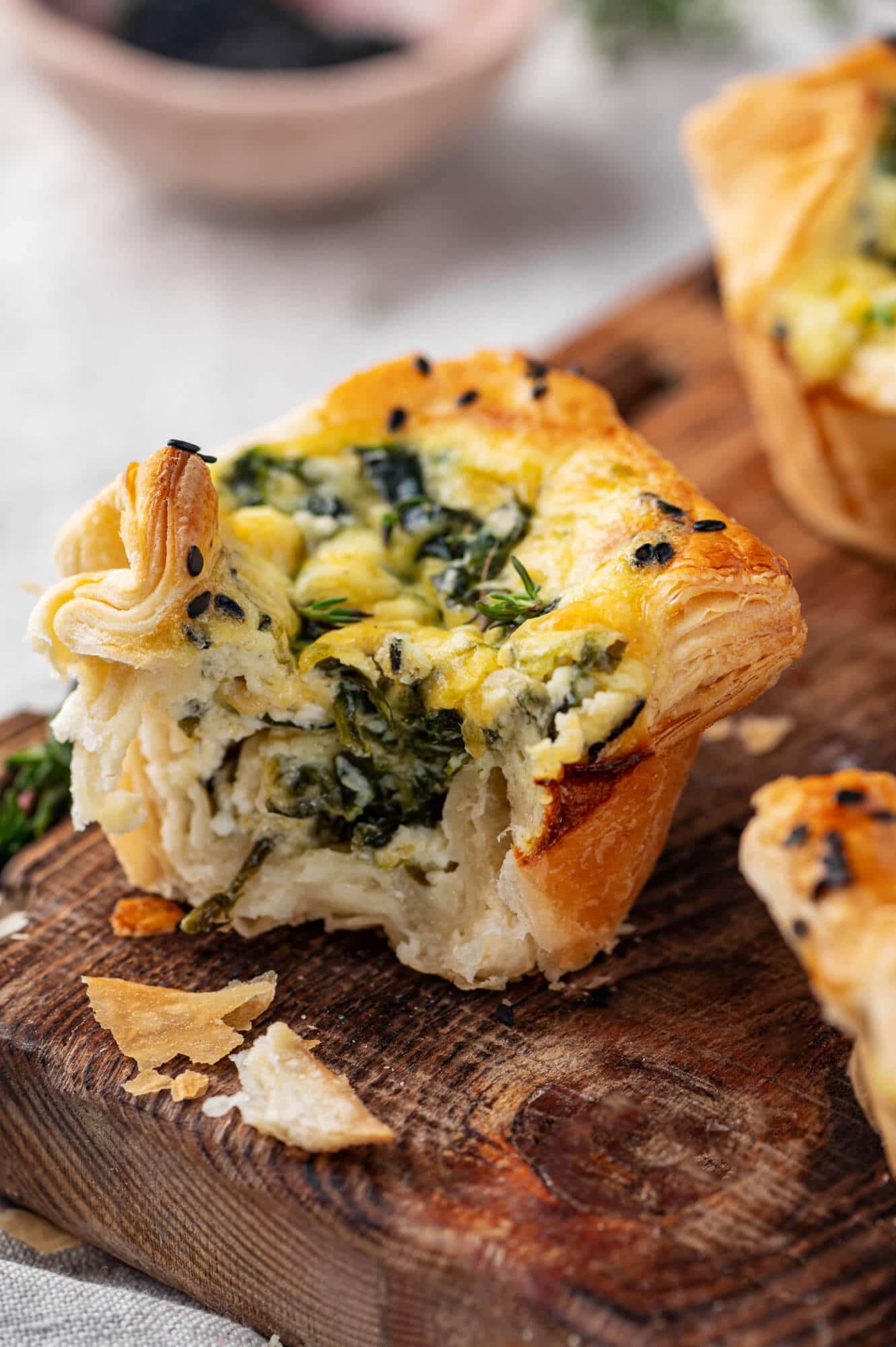 Spinach puffs on a wooden board. 