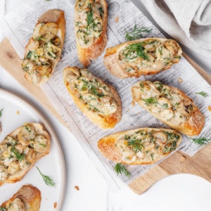 Serving mushroom crostinis on the table for a crowd.