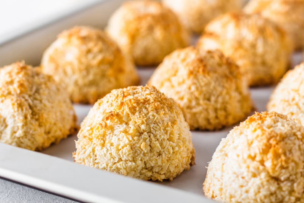 Close up of macaroons laid on a baking tray.