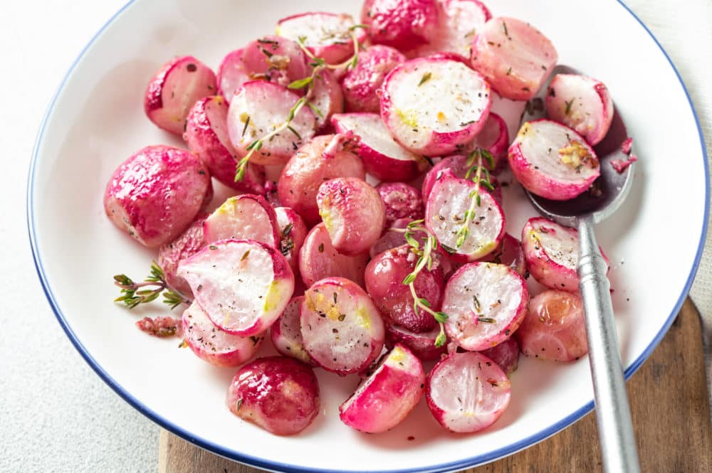 roasted-red-radishes-red-in-a-bowl-with-thyme-and-spoon-whtie-bowl-yum