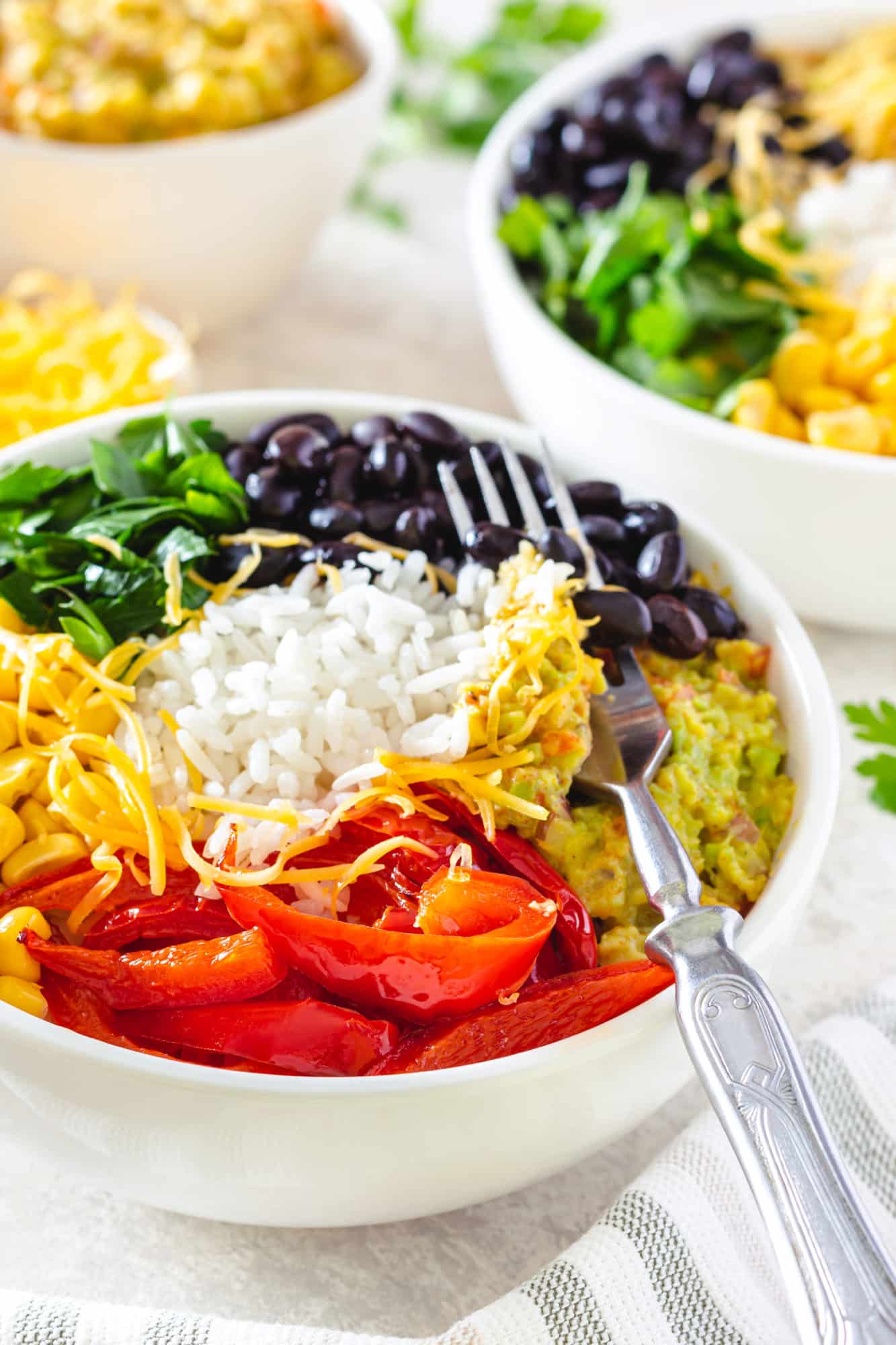 veggie-rice-bowl-on-towel-with-fork-and-parsley