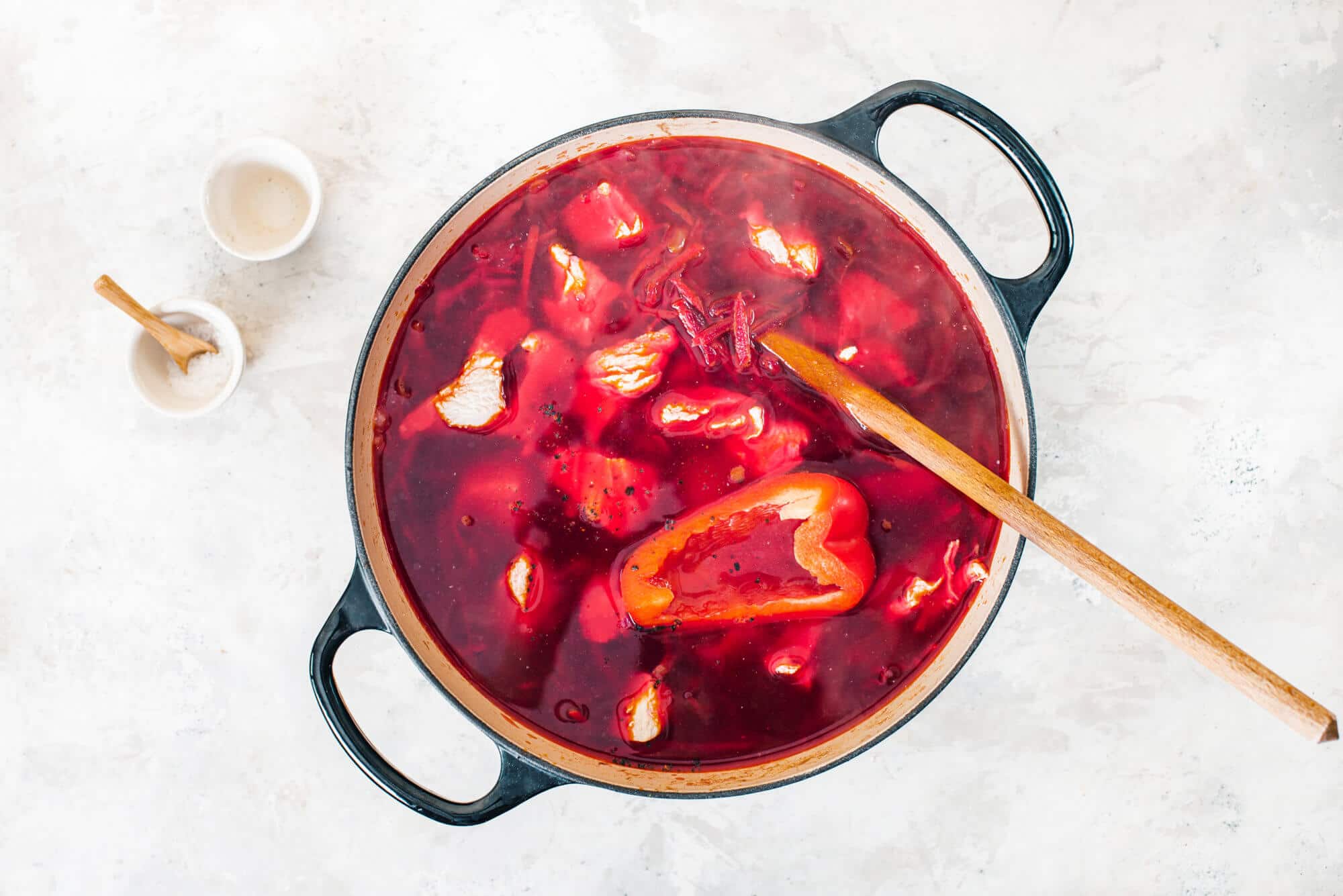 borscht-in-a-soup-pot-with-a-wooden-spoon-and-a-bowl-of-salt-on-the-side