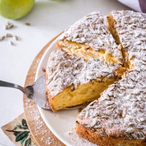 apple-cake-on-a-white-plate-with-a-spatula