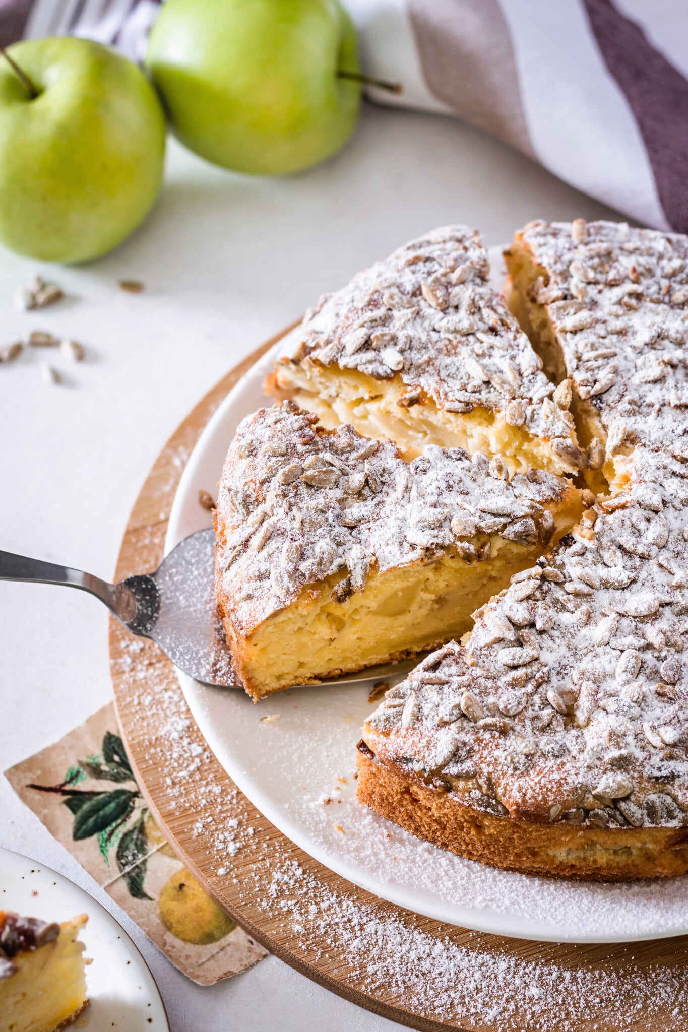 apple-cake-on-a-white-plate-with-a-spatula