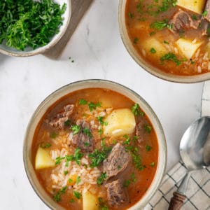 beef-soup-in-a-beige-bowl-with-a-spoon