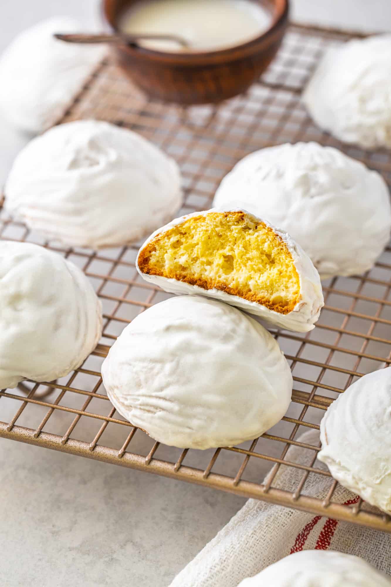 a wire rack with glazed vanilla cookies on it.