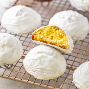 a wire rack with glazed vanilla cookies on it.