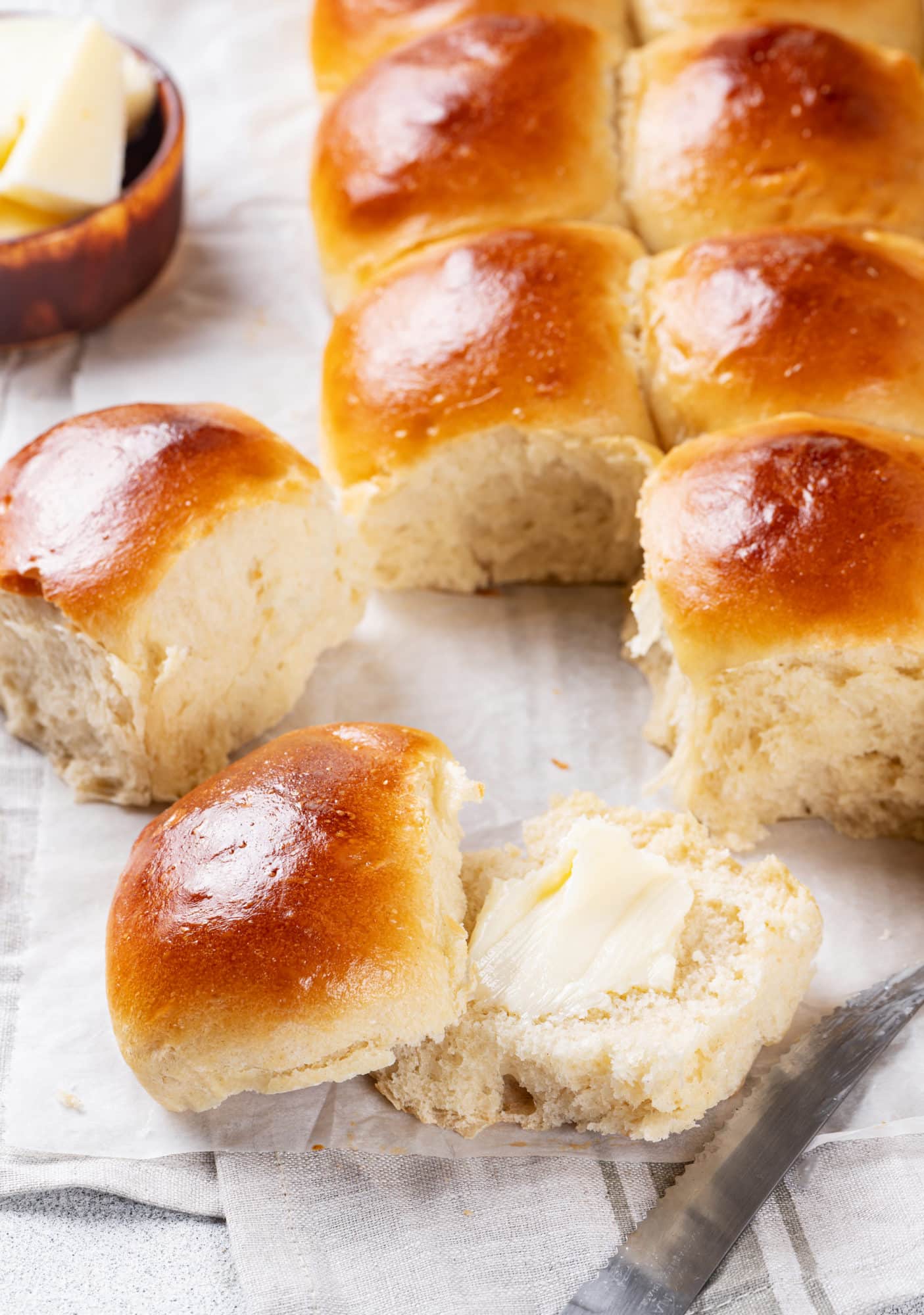 dinner-rolls-with-a-knife-butter-on-a-towel