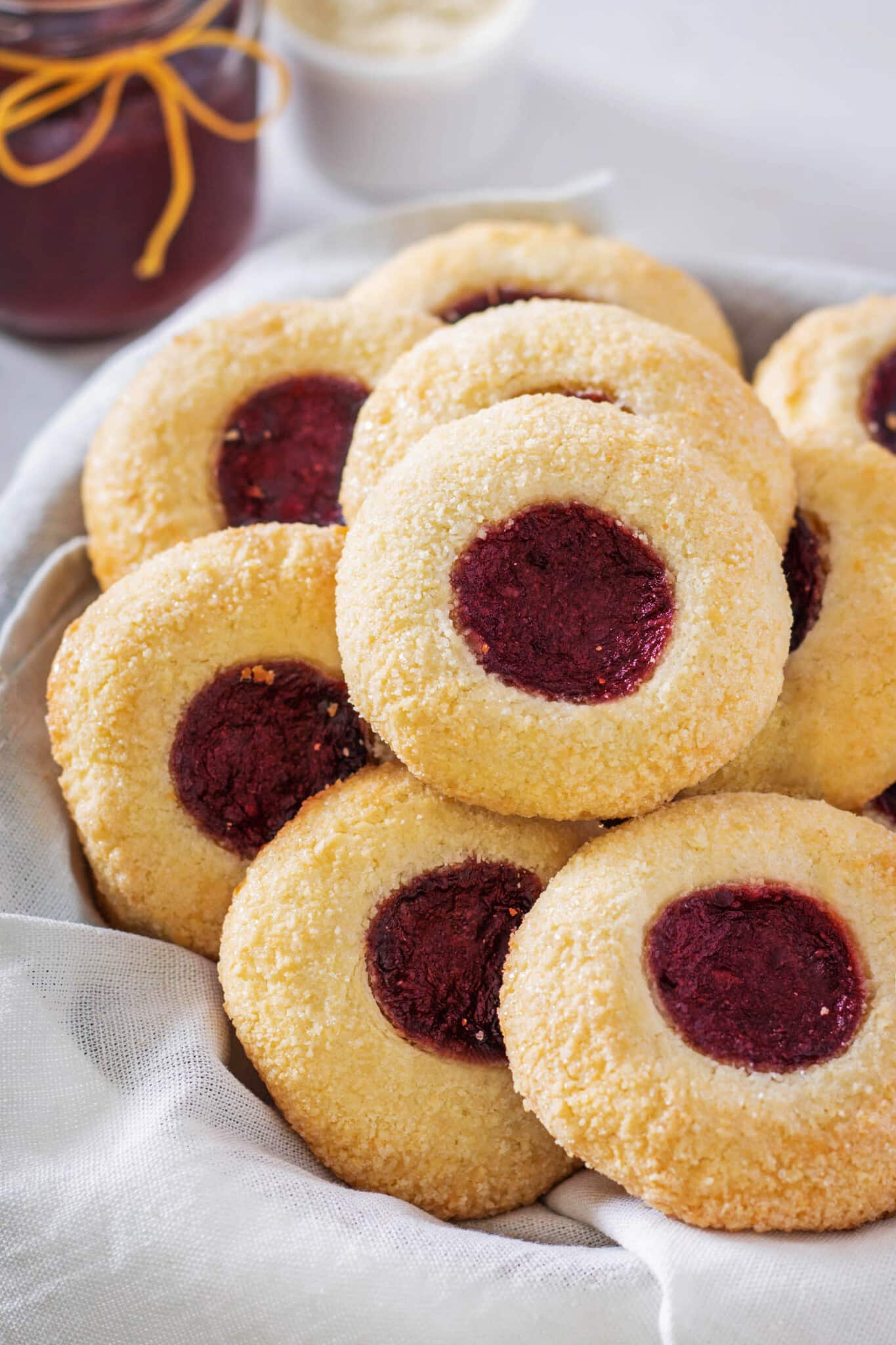 thumbprint cookies on a white plate.