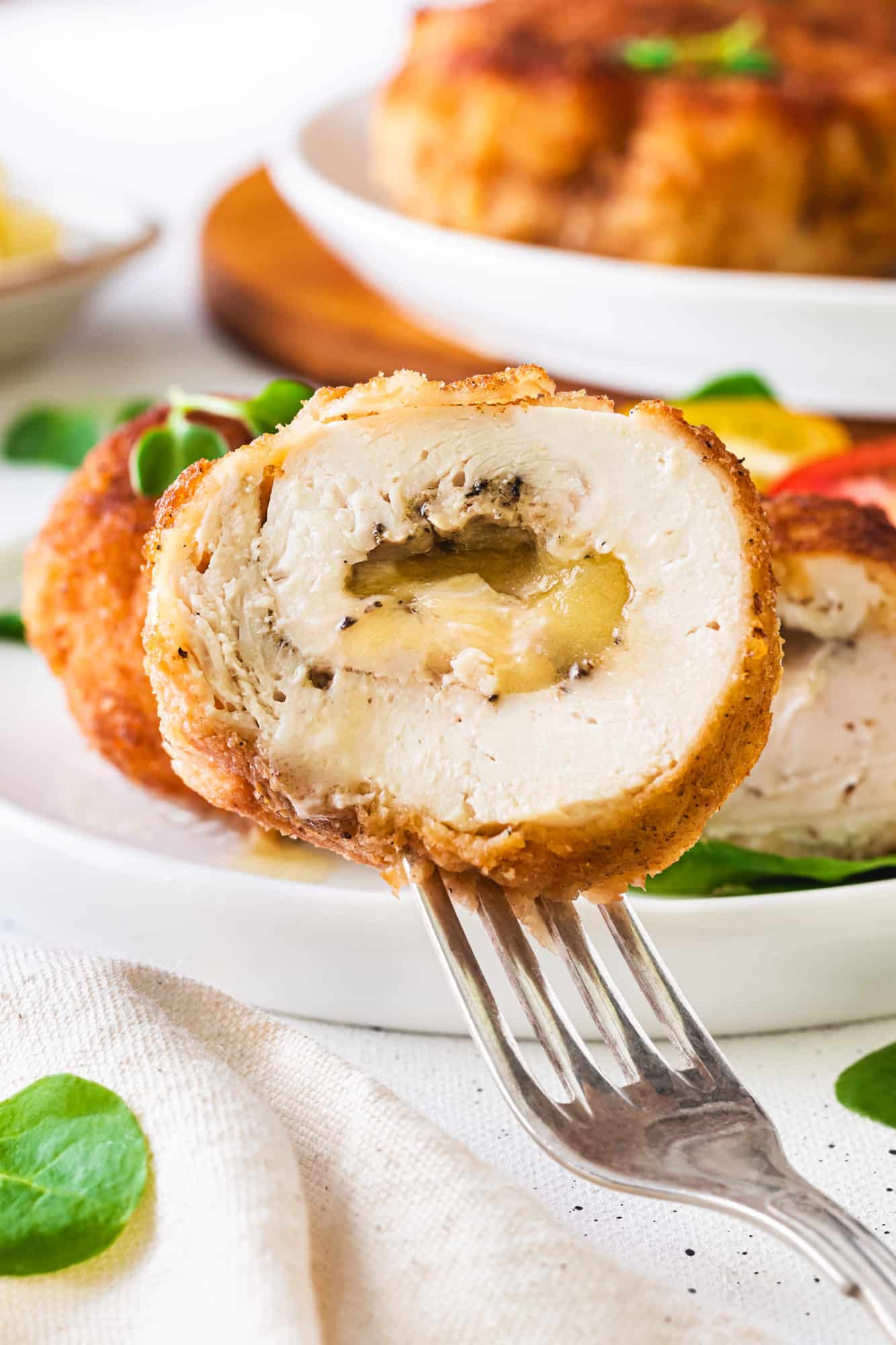 halved stuffed chicken on a fork.