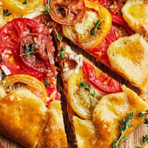 close up of baked tomato galette with rosemary on top.