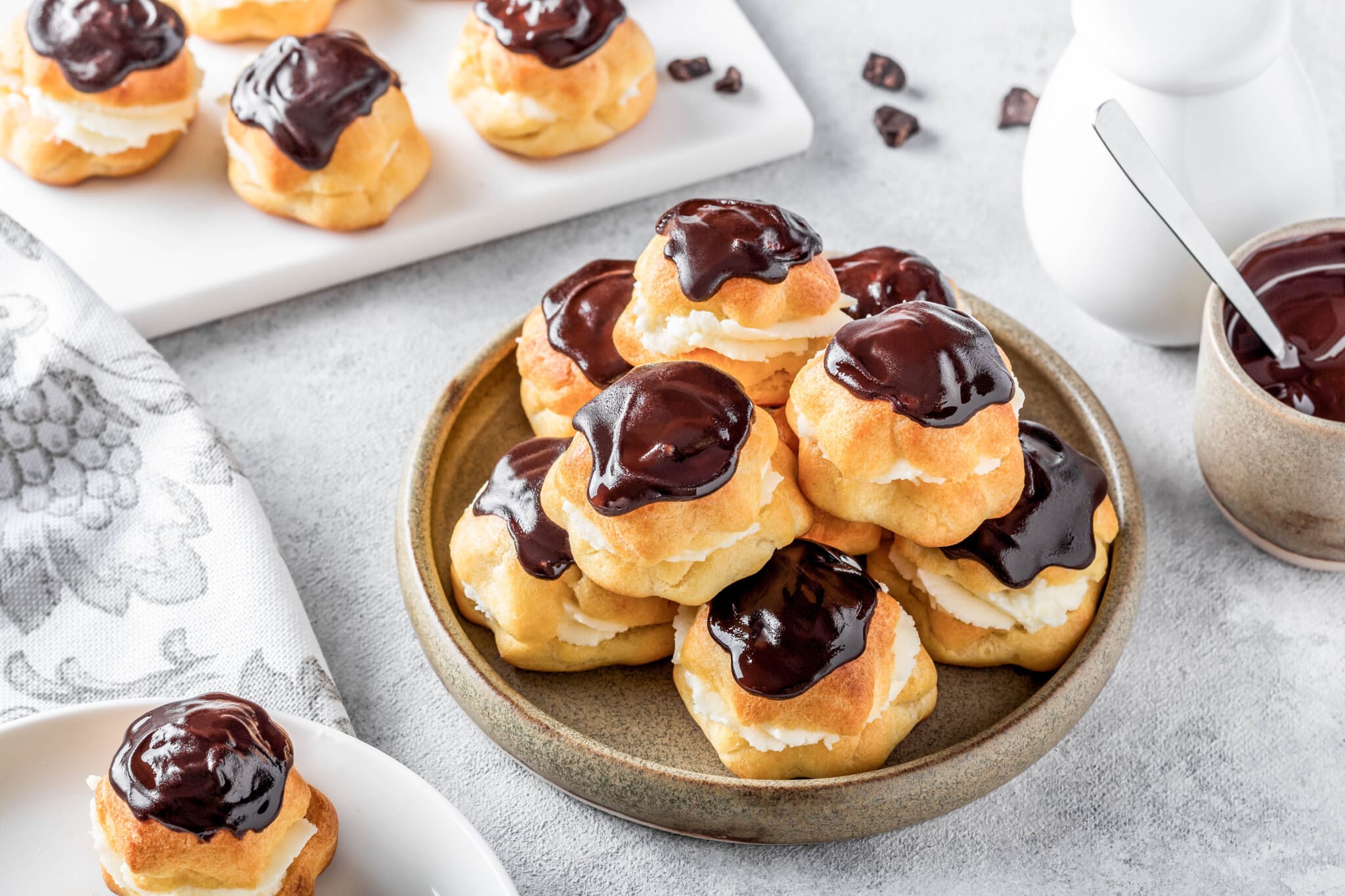 eclairs-covered-in-chocolate-in-a-brown-plate