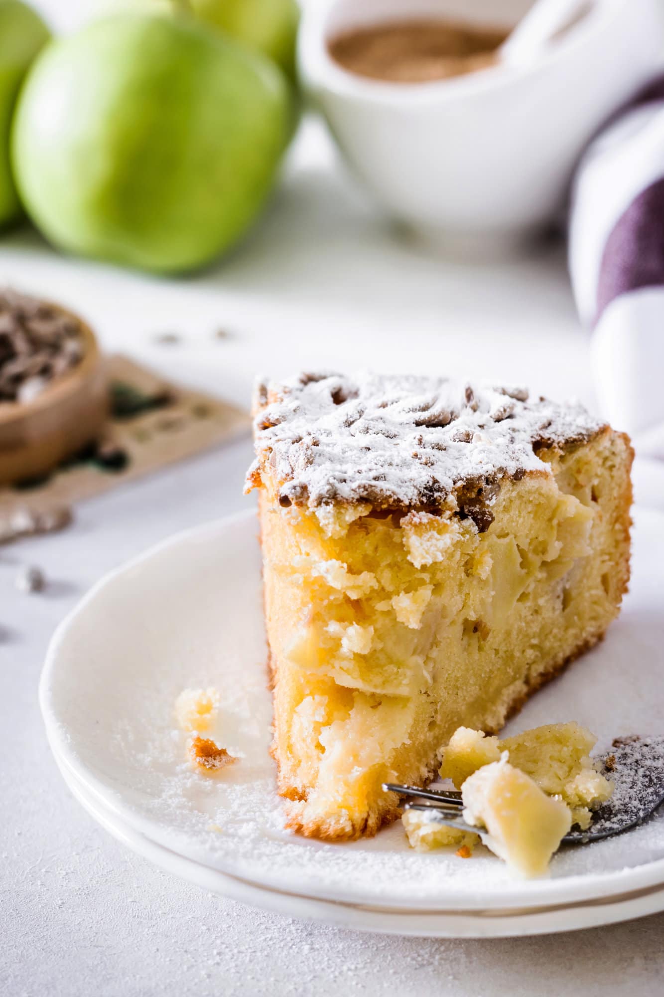 apple-cake-slice-on-a-white-plate-with-a-fork