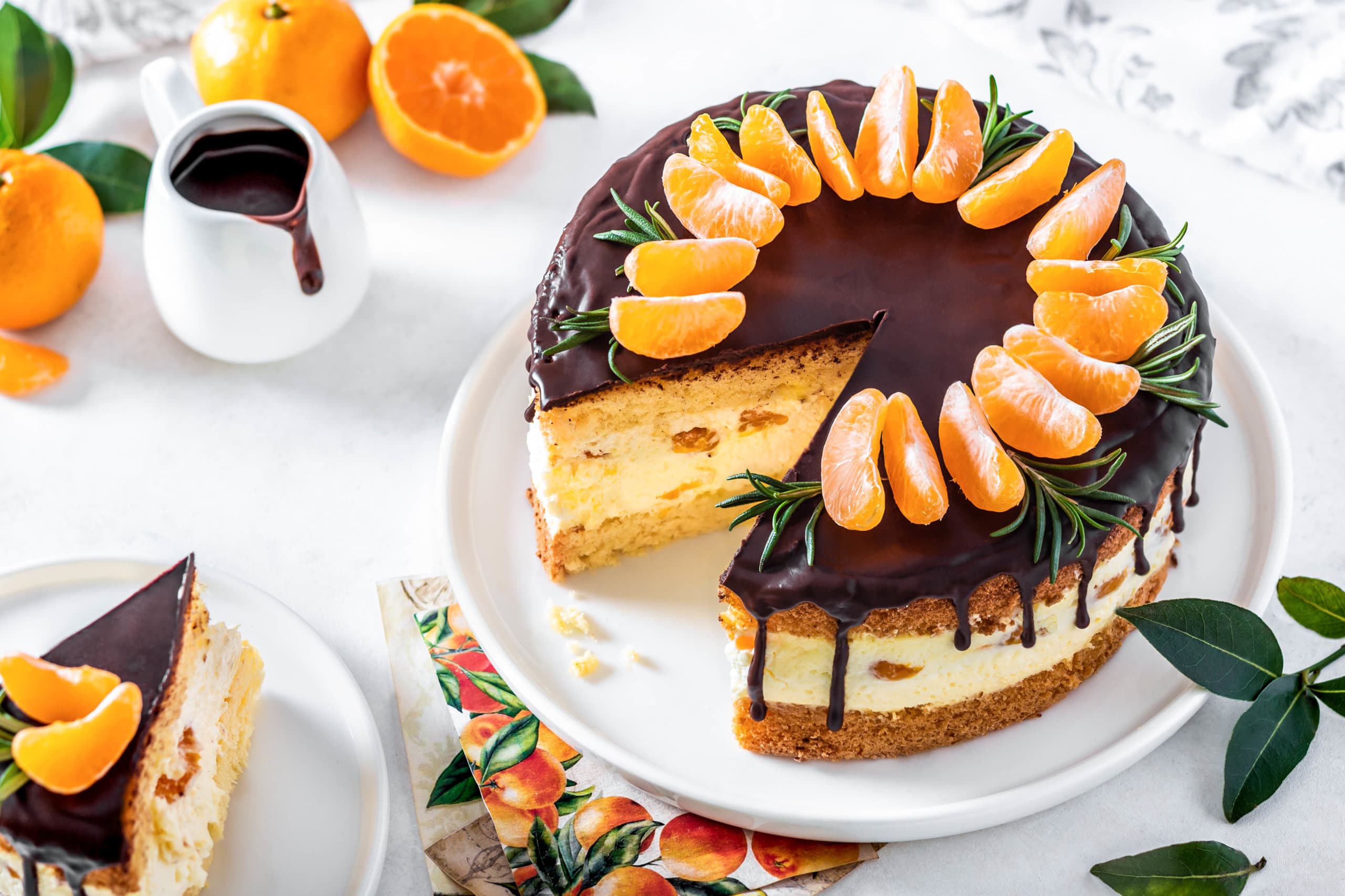 mandarin-mousse-cake-on-white-plate-with-mandarins-on-the-side