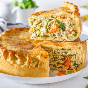 chicken pot pie with one slice removed with the filling showing.