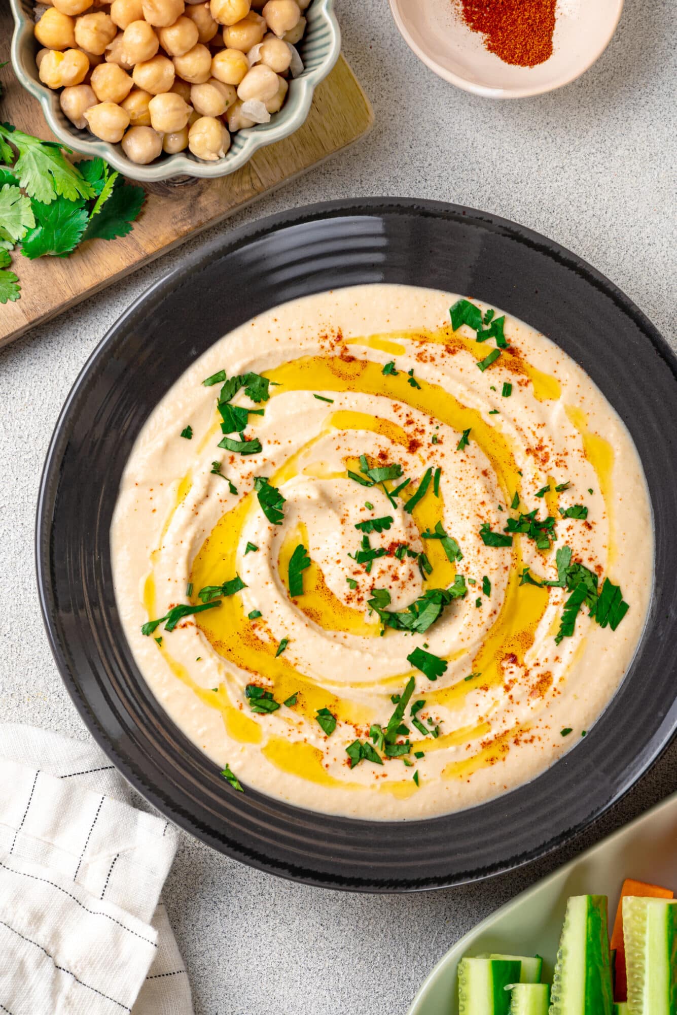 A bowl of hummus with olive oil and seasonings.