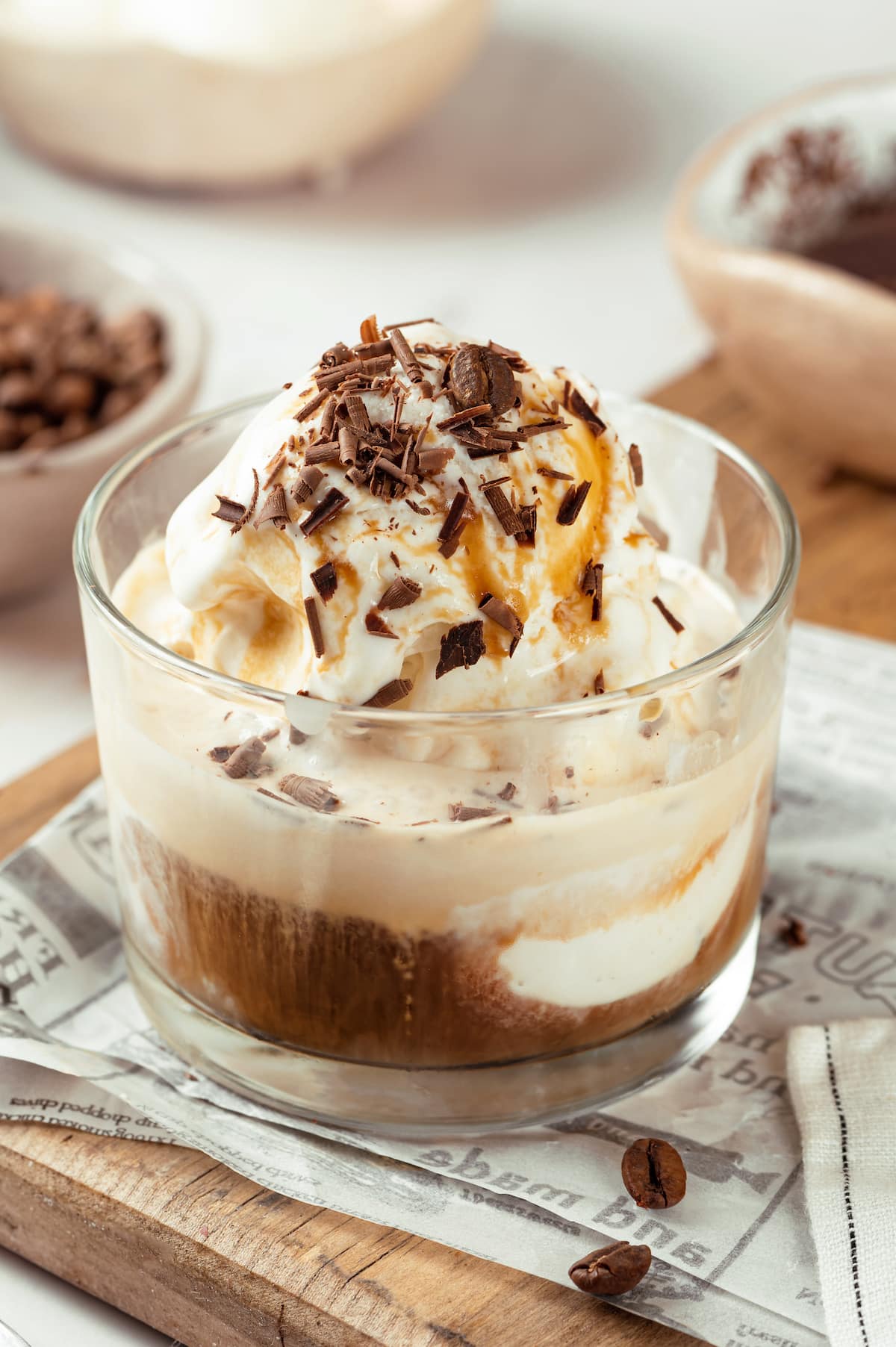 homemade affogato in a small glass cup with chocolate shavings and vanilla ice cream melting with the espresso