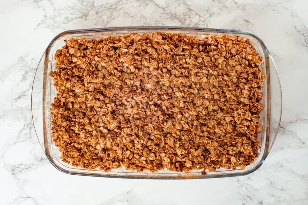 Baked apple crisp in a glass baking dish.